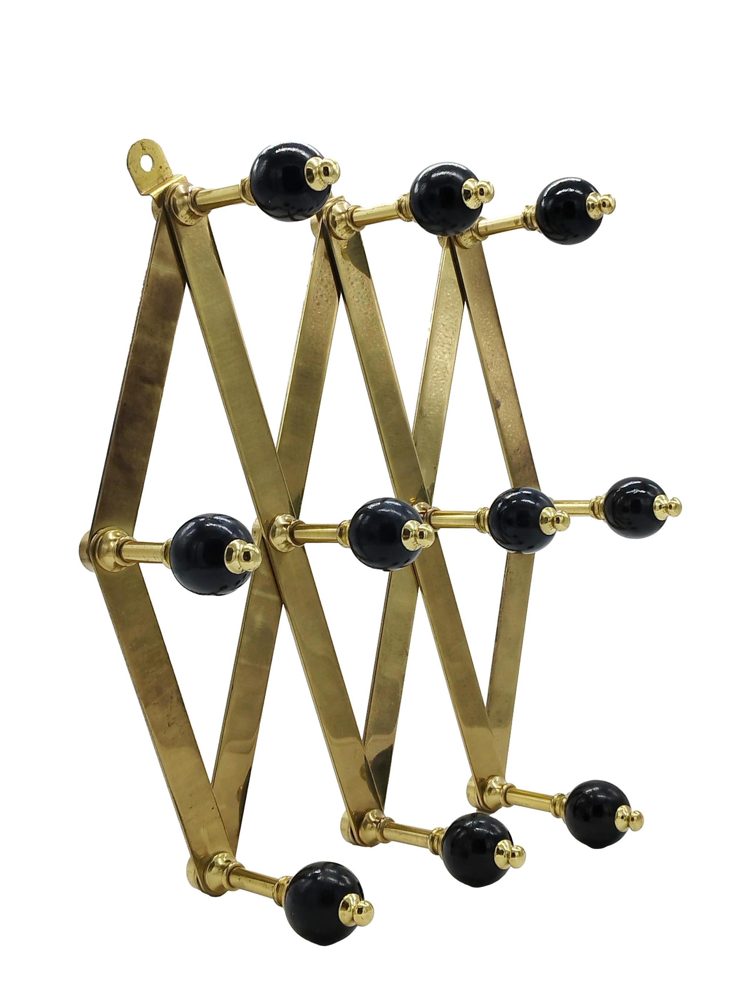 Adjustable brass and Bakelite coat stand by Luigi Caccia Dominioni for Azucena. Adjustable brass frame with black Bakelite knobs.
Very good condition: the brass has been polished, but shows little oxidation as can be seen in the photos.

