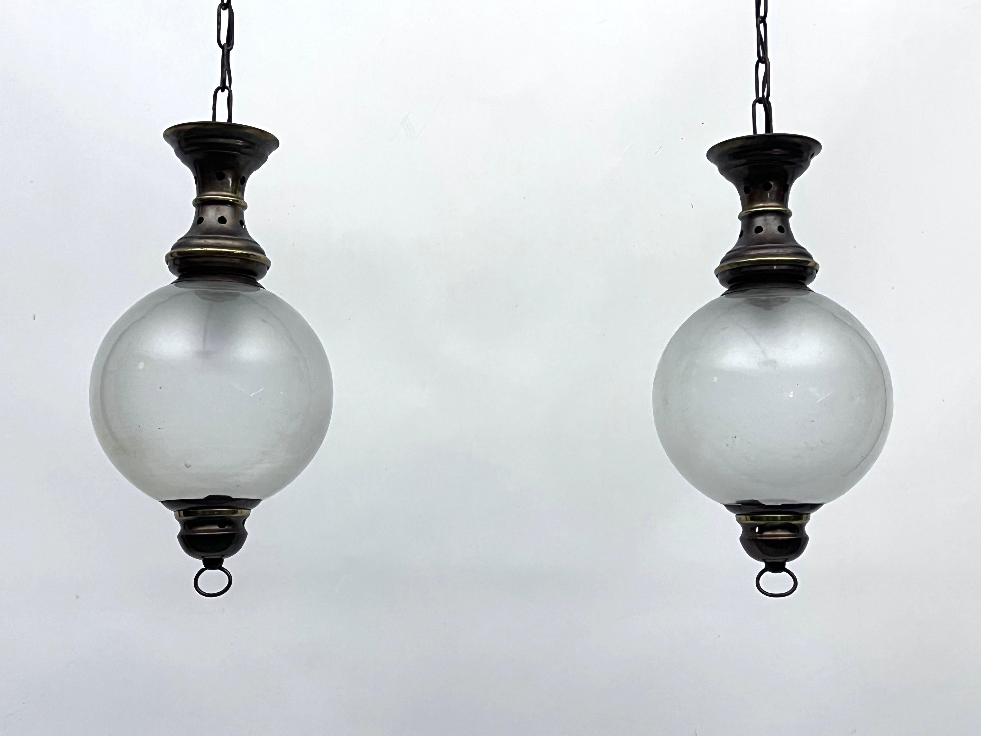 Good vintage condition with normal trace of age and use for this pair of chandeliers made from brass and glass in the manner of Caccia Dominioni for Azucena. Full working with EU standard, adaptable on demand for USA standard.
