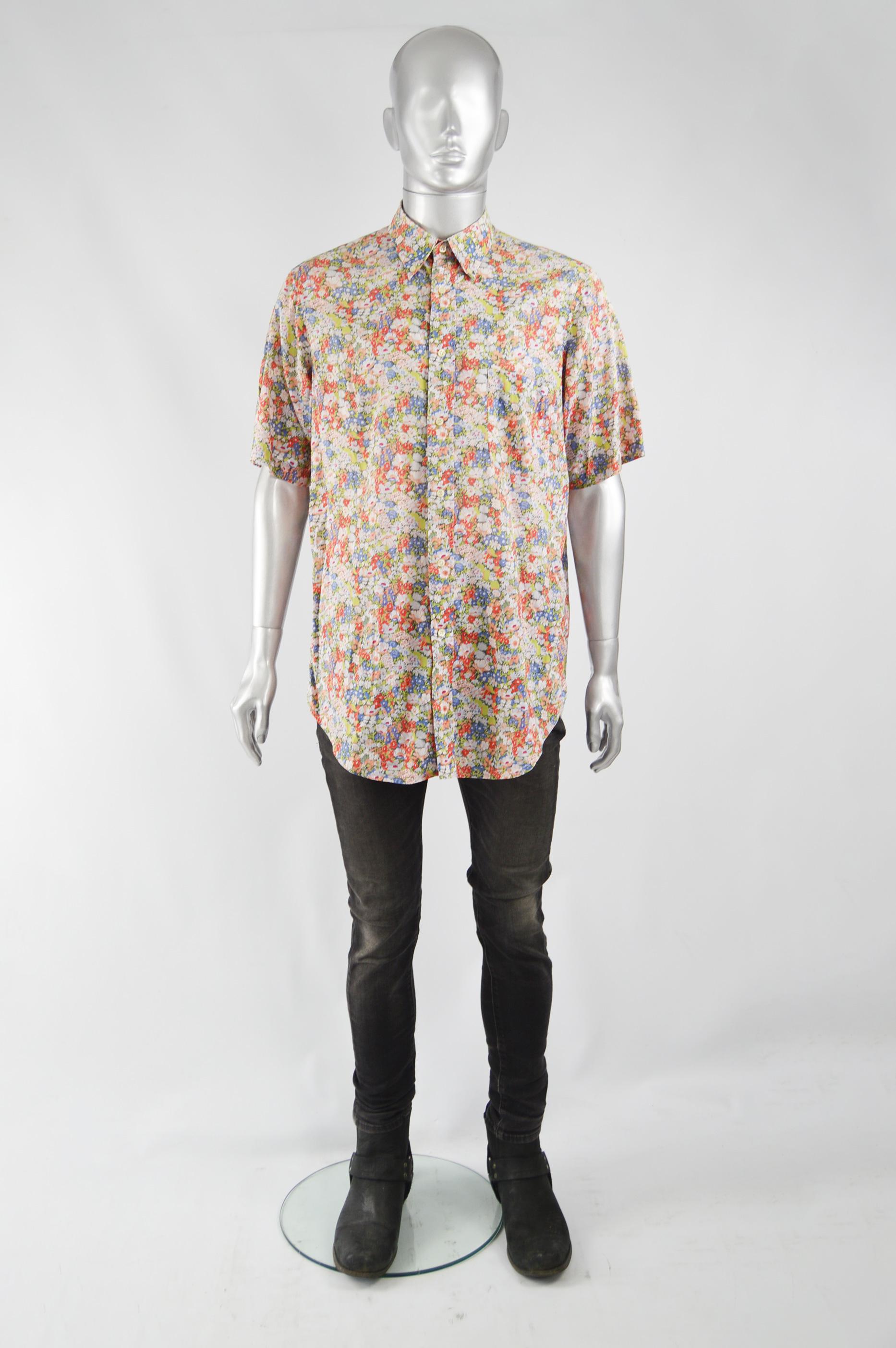 An amazing floral printed cotton shirt from the 80s by luxury French fashion house Cacharel, with a button down collar and short sleeves. 

Size: Label has faded, fits like an XL to XXL. Please check measurements. 
Chest - 46” / 117cm 
Waist - 46” /