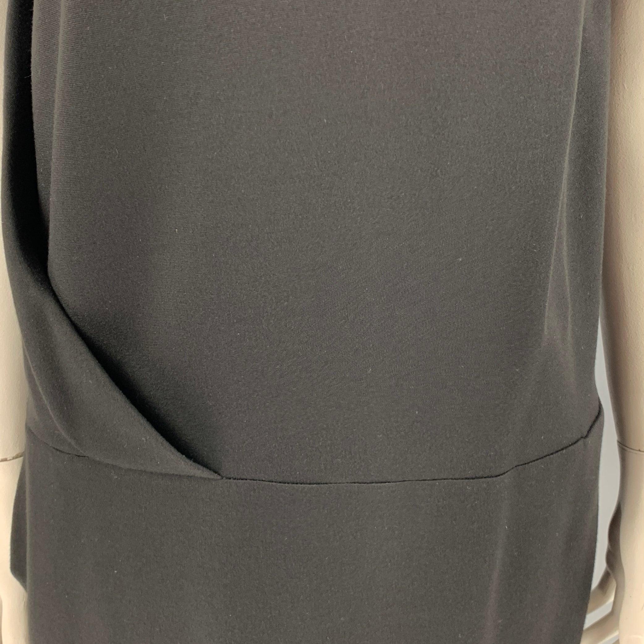 CACHAREL dress
in a black nylon blend fabric featuring a sleeveless style with drape and fold details, drop waist, two pockets, and side zipper closure.Very Good Pre-Owned Condition.
Mark at hem. 

Marked:   IT 48 

Measurements: 
 
Shoulder: 18