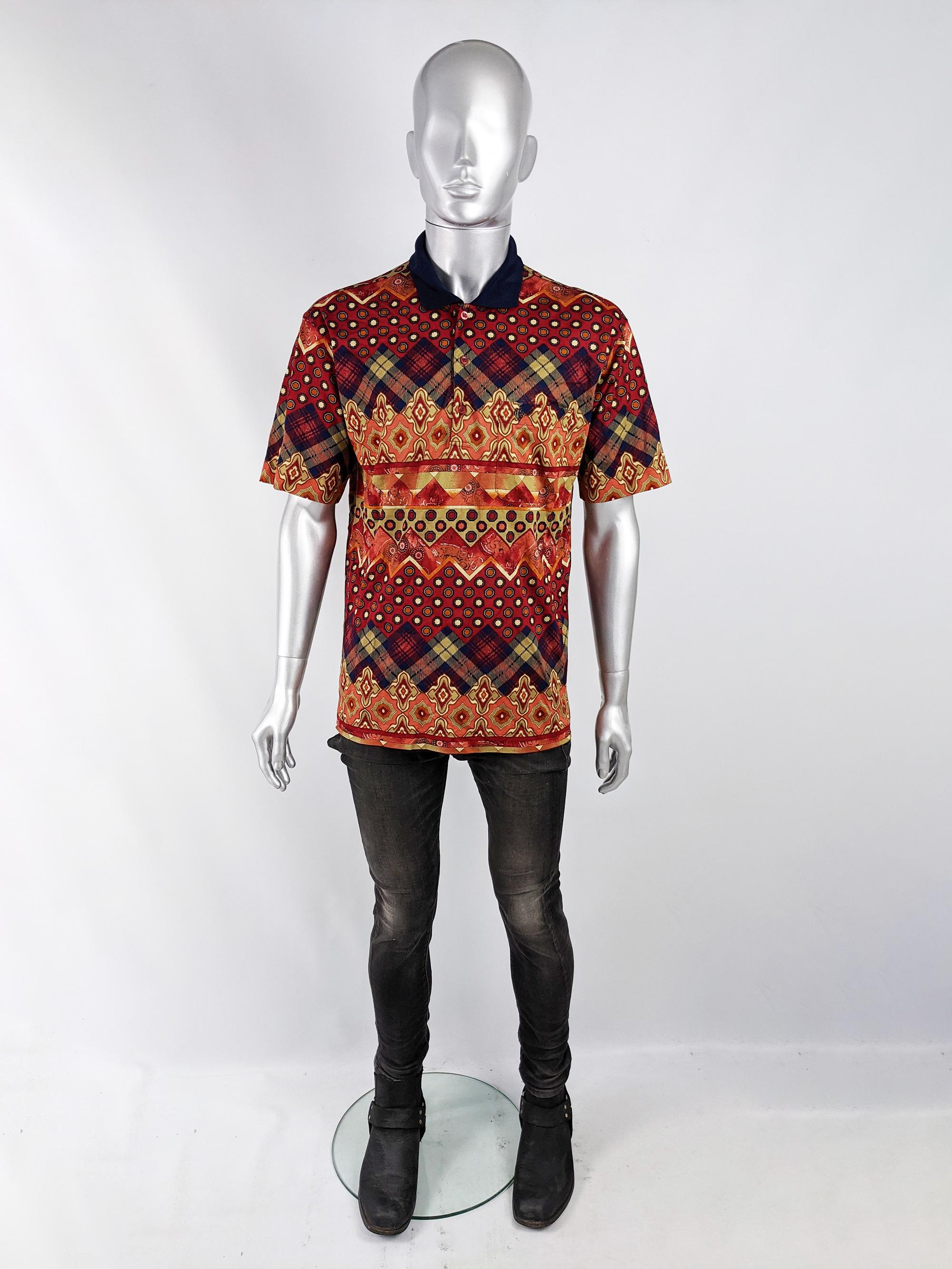A stylish vintage mens polo shirt from the 80s by luxury French fashion house, Cacharel. In a lightweight, red and navy bold patterned cotton piqué with checked and paisley style patterns throughout.

Size: Marked International V which equates to a