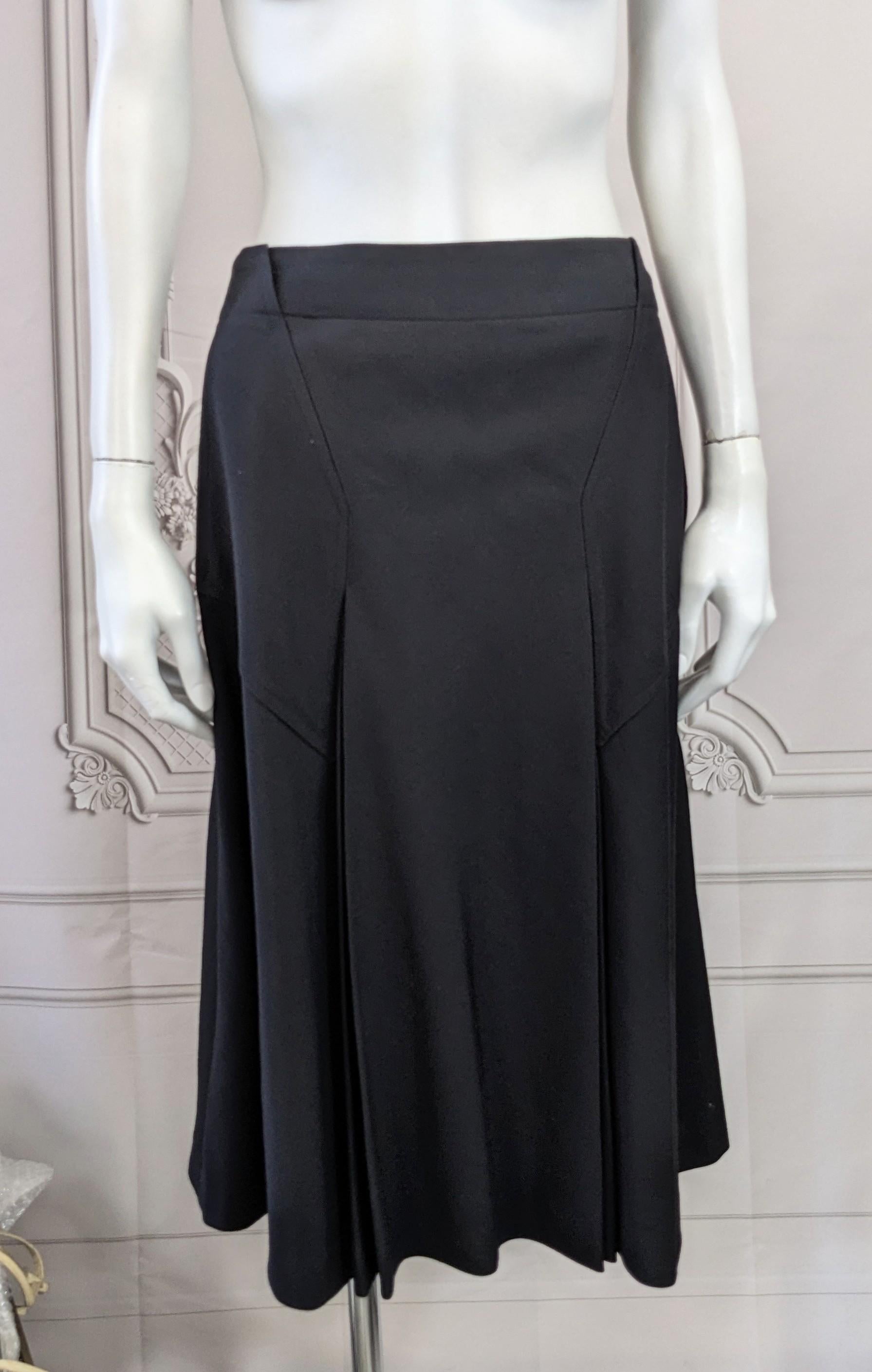 Cacharel Black Wool Twill Pleated A Line Skirt from the 1970's. Great cut and detailing with cool angled panels and pockets. Panels release into double pleats on front and back. Side zip entry. Great design. 1970's France. Small size. Vintage size