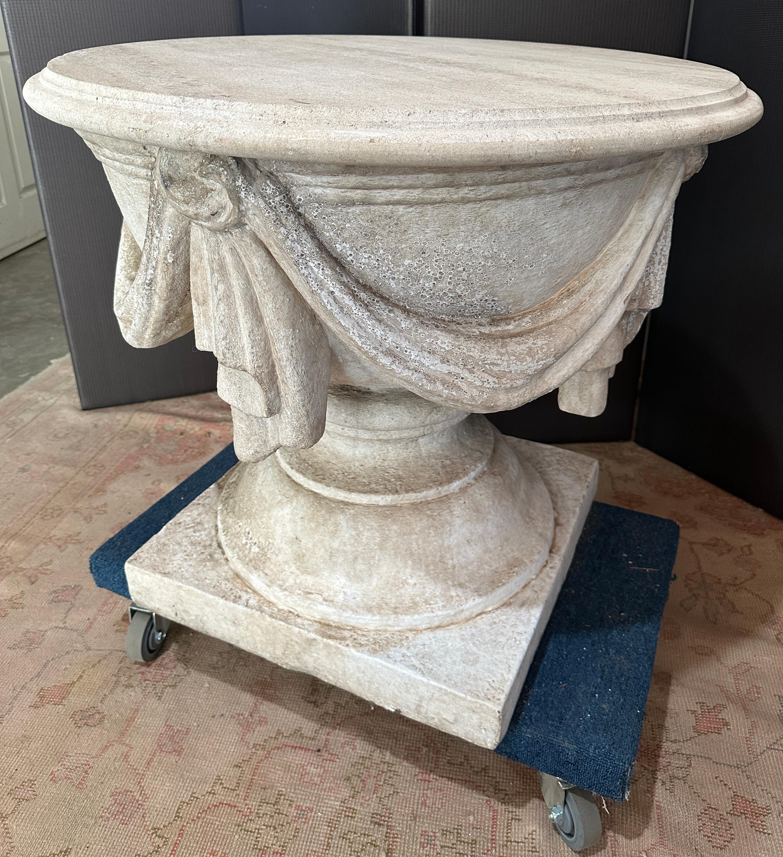 Un'incantevole base in pietra drappeggiata Cache` con piano in travertino. Può essere utilizzato
all'interno o all'esterno. La base può supportare un piano in vetro rotondo più grande
per la cena.
Il motivo dello swag viene utilizzato sia in