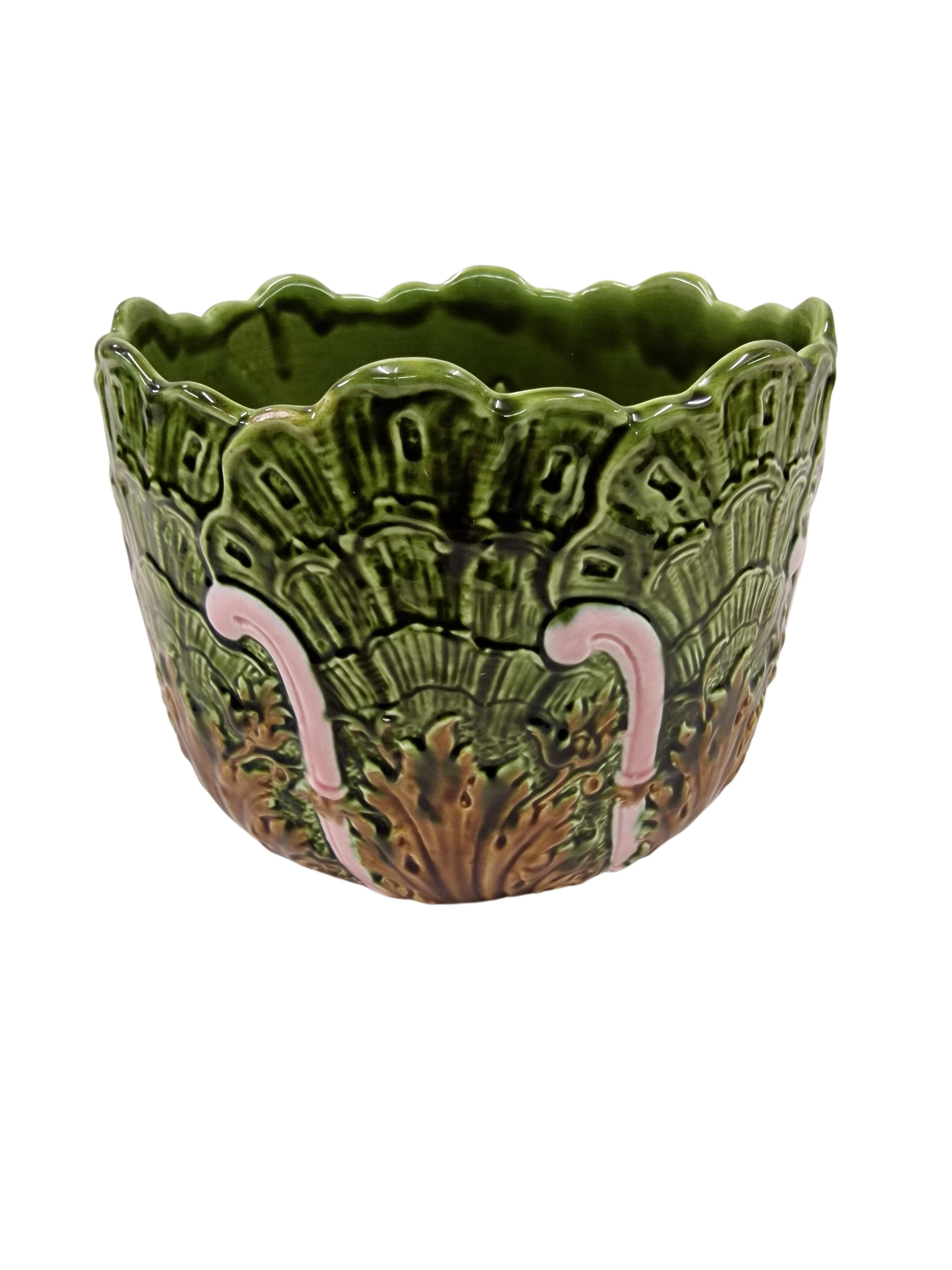 Wonderful flowerpot of Schütz Cilli, from the early 20. Century. This object is a beautiful example of floral Art Nouveau in a radiant glaze in different shades of green and light pink. The shape is beautiful in shell design with frilly-like finish