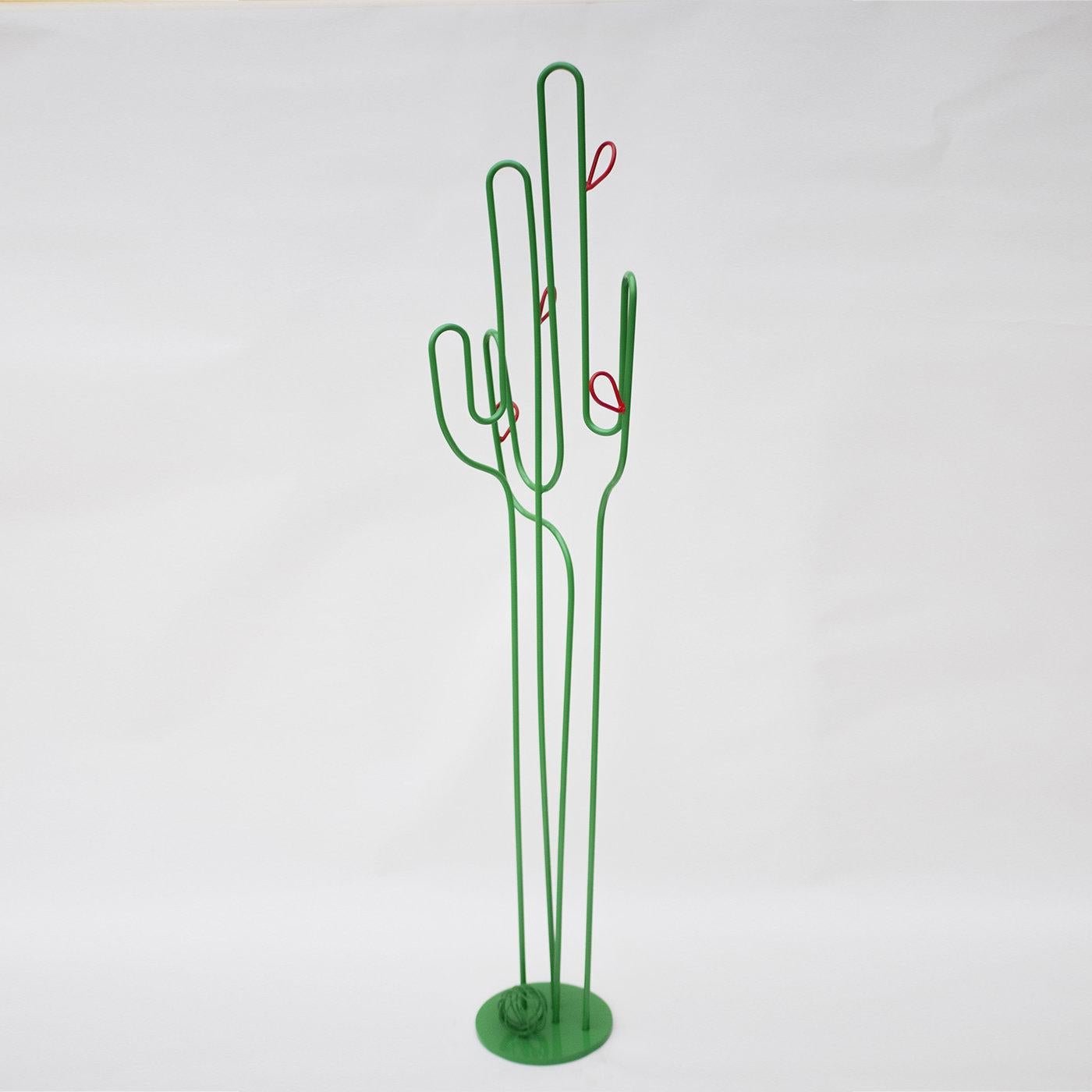 The artist conceived this vibrant piece of functional decor to simultaneously serve as contemporary sculpture and fancy coat rack. Crafted by hand from wrought iron, it flaunts a graceful and airy profile inspired by cactuses. A round base stands as