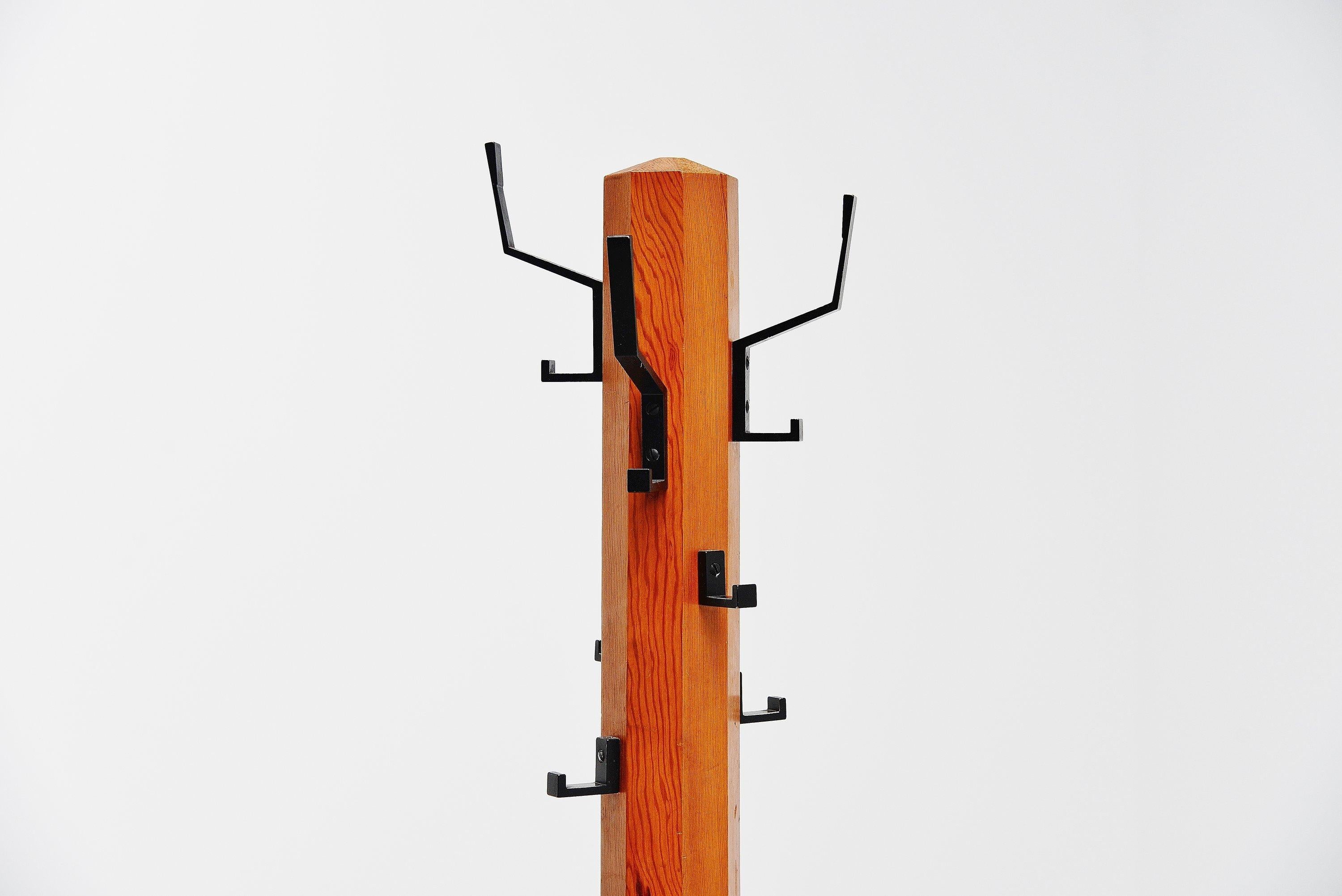 Stunning cactus shaped coat stand made by unknown designer or manufacturer, Sweden 1970. The coat stand has a black painted metal base and a solid pine wooden structure with black painted aluminium hooks which were typical for the 1970s. This coat