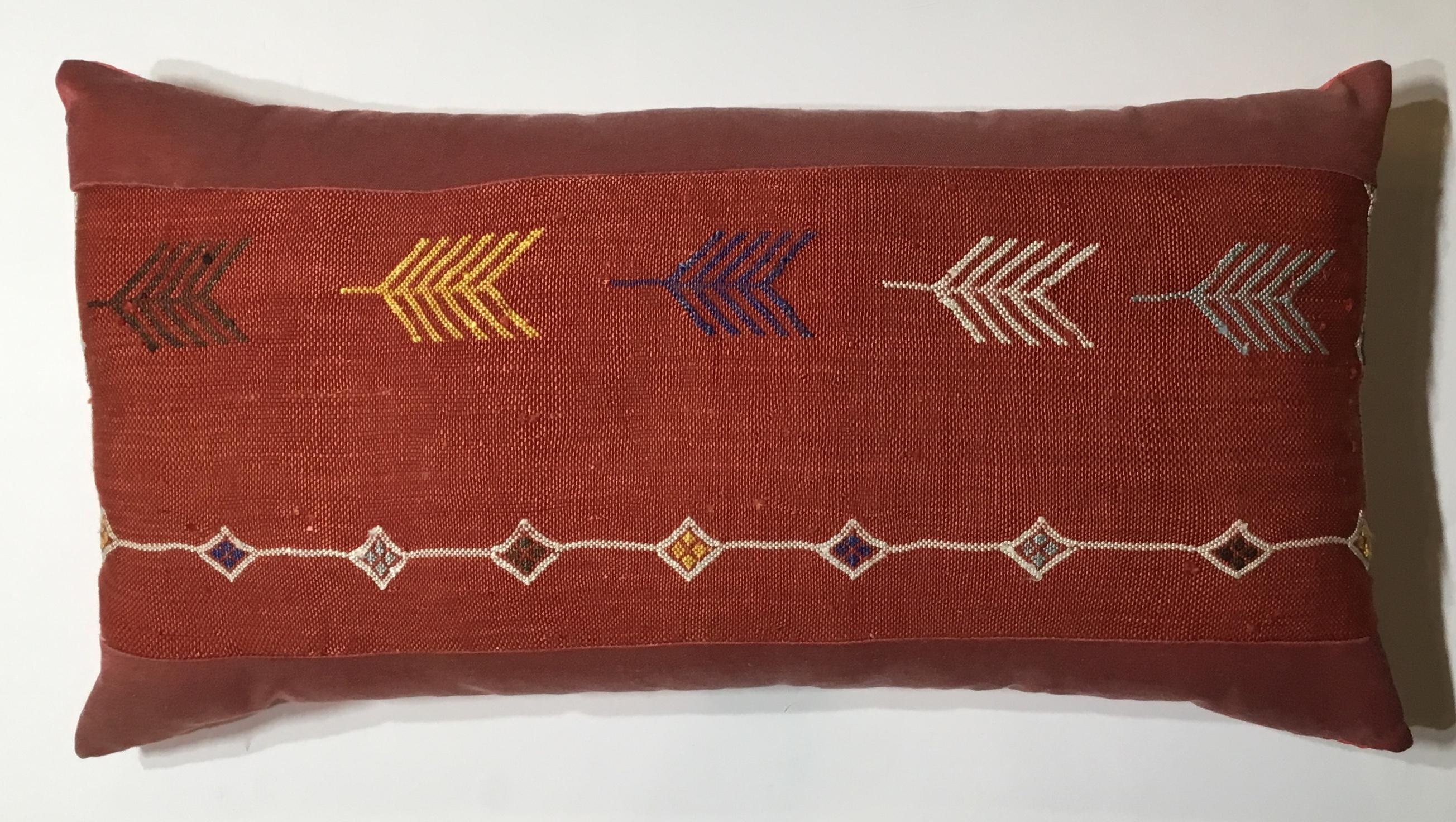 Beautiful pillow made of handwoven flat weave textile, with colorful geometric motifs on a red background. Silk side trimming and fine Italian silk backing. Fine quality insert.