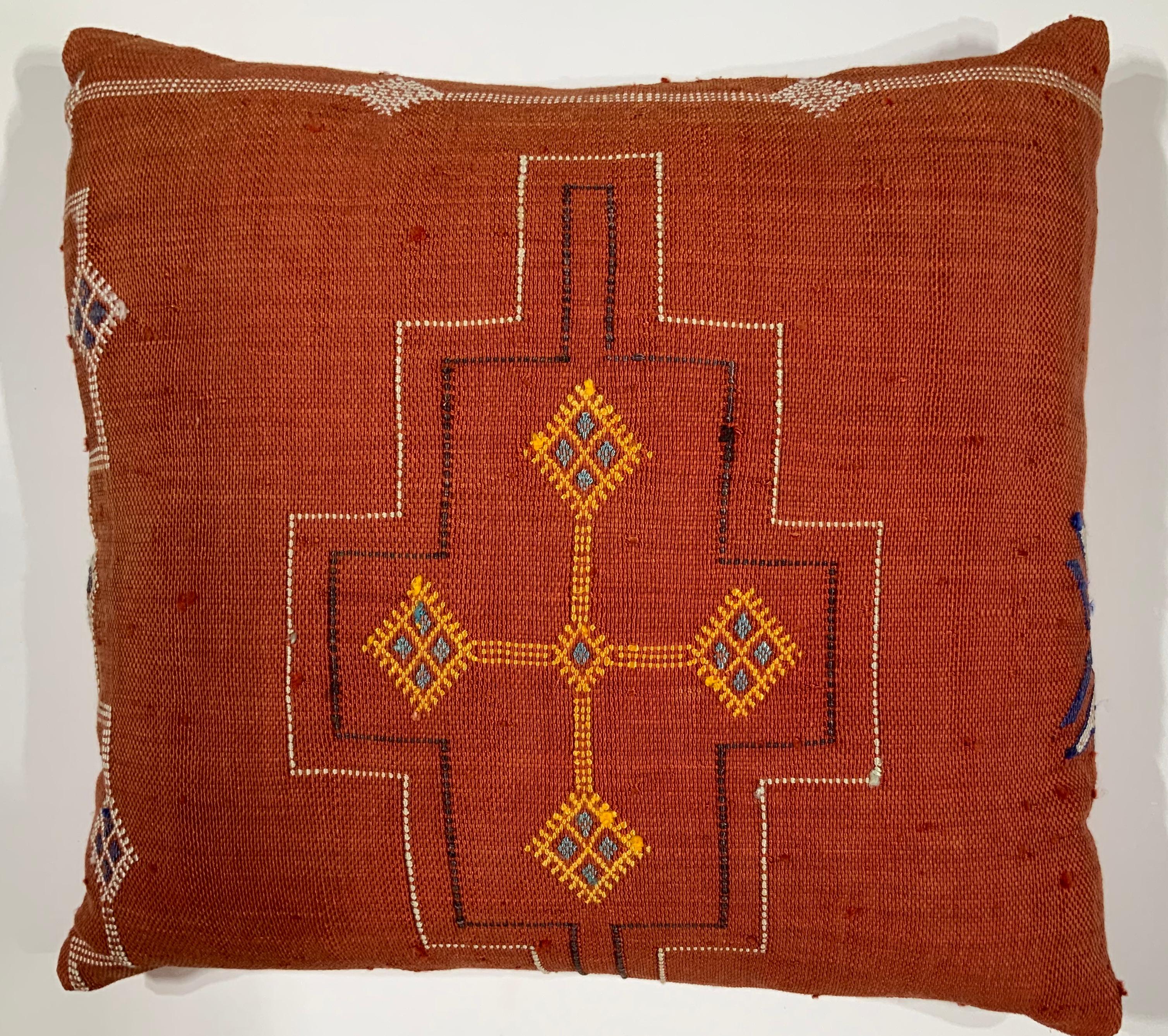 Beautiful pillow made of handwoven flat-weave textile with multi colors geometric motifs on a red background, fine silk backing frash inserts.
 