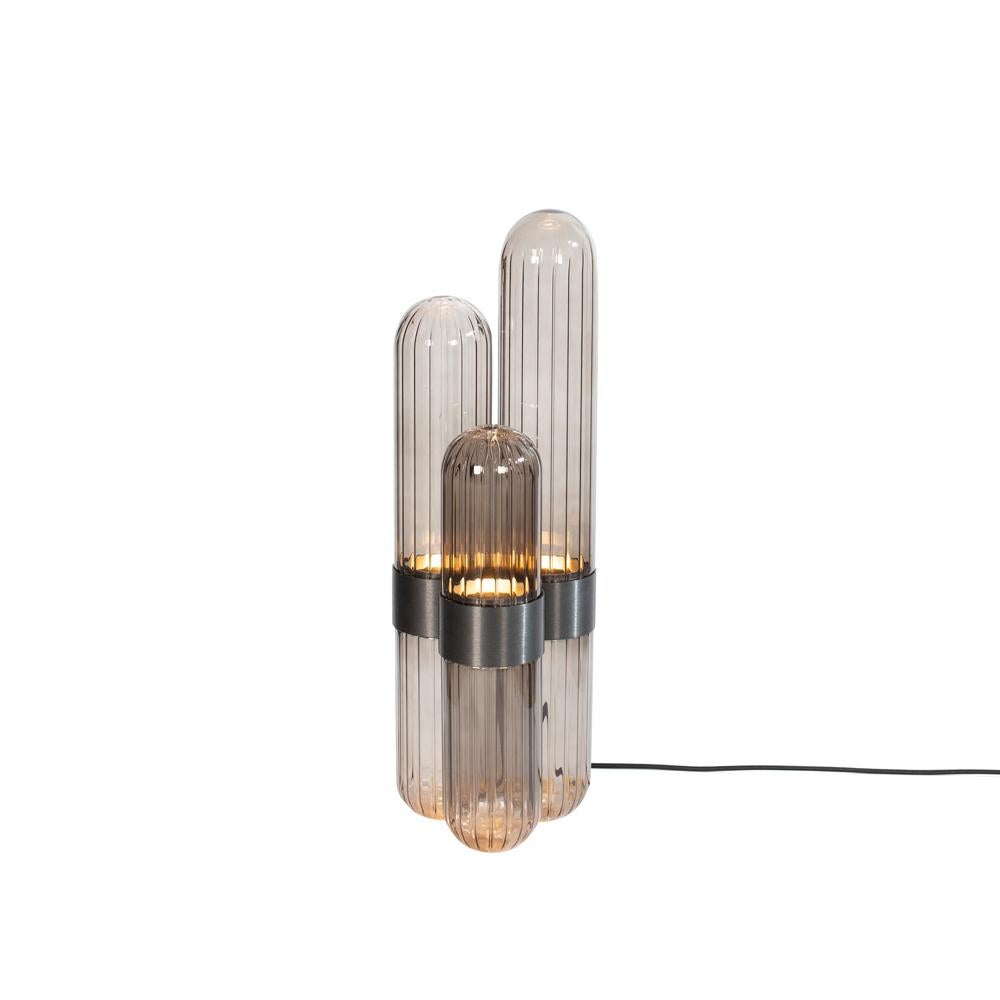 Cactus small floor lamp grey brass by Pulpo.
Dimensions: D20 cm x H63 cm.
Materials: Borosilicate glass,steel, brass, aluminium
Also available in different finishes: transparent black, transparent brass, smoky grey black, smoky grey brass.

The