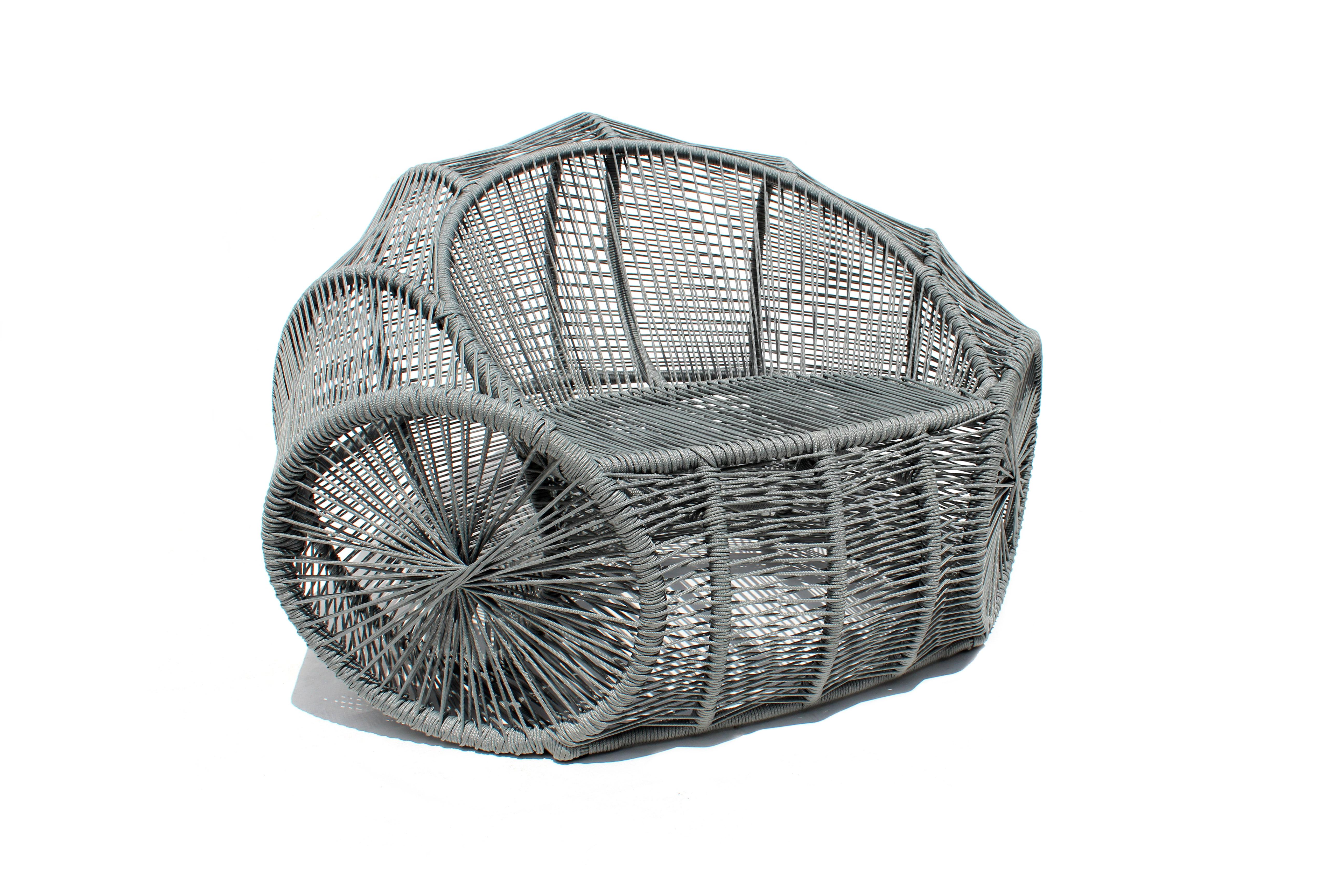 The design for this wicker armchair, made in a contemporary Brazilian design, comes from the liana basket that serves to carry groceries and supplies, transported by pack animals in the countryside of the Brazilian Northeast.