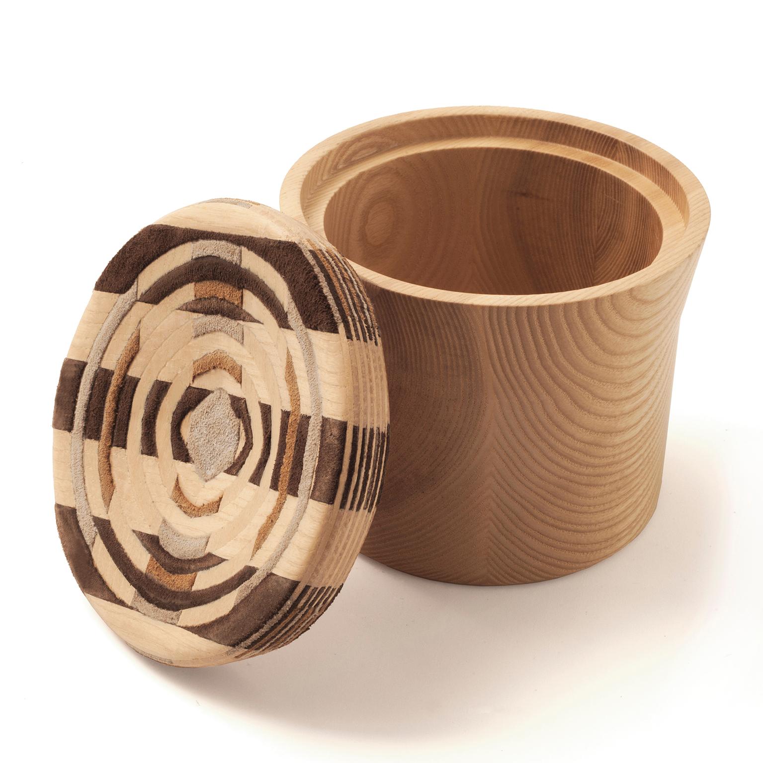 Solid wooden boxes with a unique lid, intricately made out of layers of thick veneer and fine leather pieces. The layers are carefully assembled and glued together in a warp and woof manner to create a thick block, which is then simulated in 3D