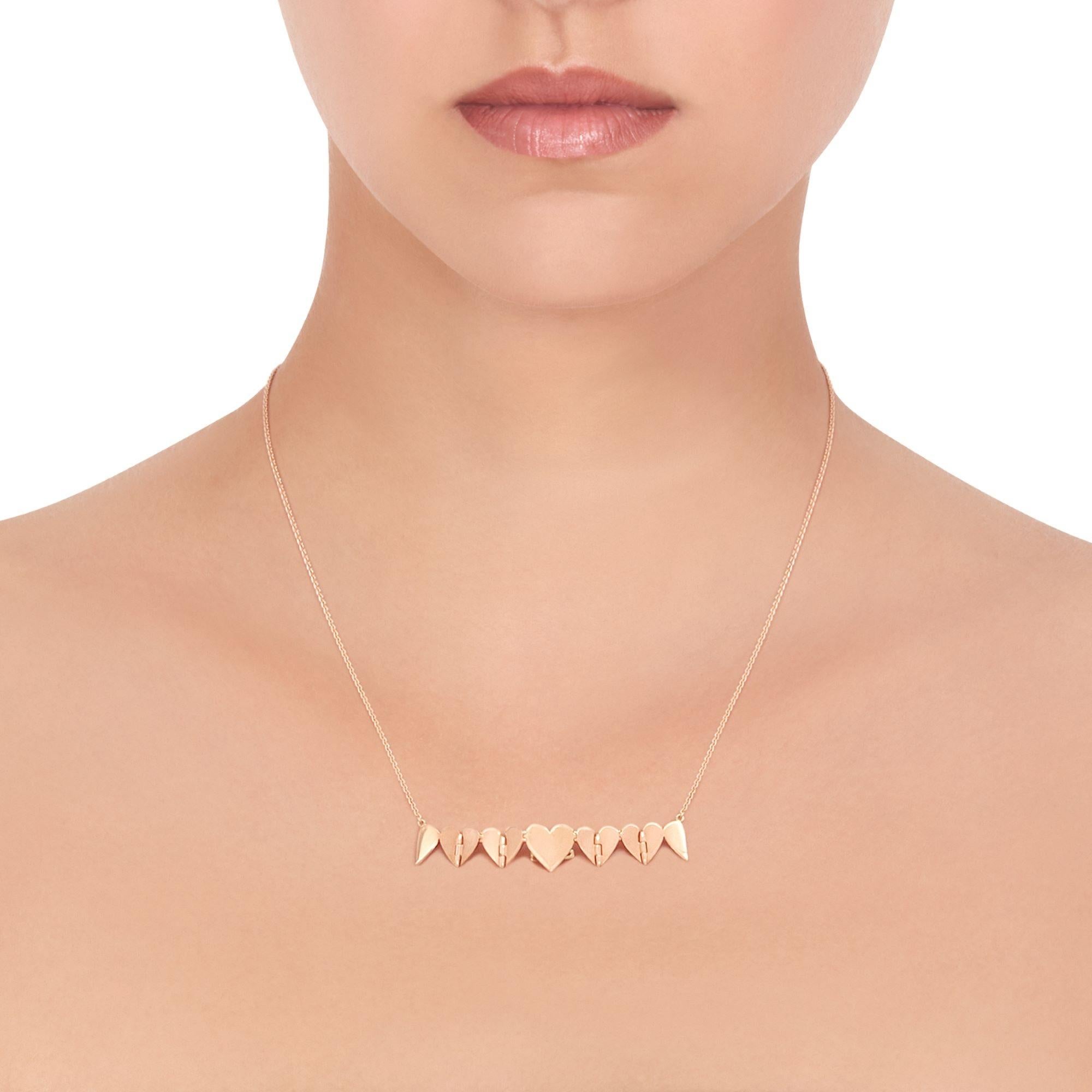 Euphoria of love. The classic heart motif pendant unfurls and expands like fluttering butterflies brought on by new love. Handcrafted in high polished 18K yellow gold. Adjustable to 16