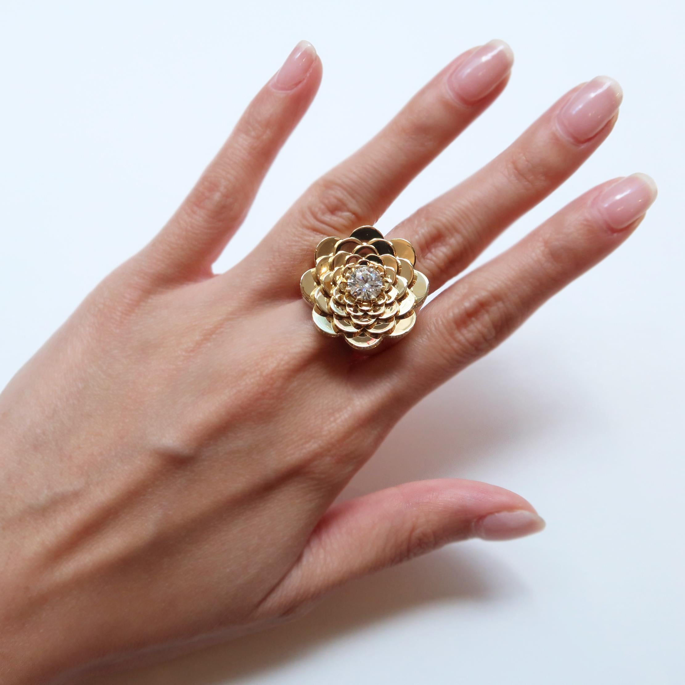 Intricately detailed blooms. A layered petal pattern adorned with pave diamonds that surround the outer petals, and a glimmering diamond center, creates a boldly elegant cocktail ring. Handcrafted in high polished 18K yellow gold and 1.75cttw GVVS-2