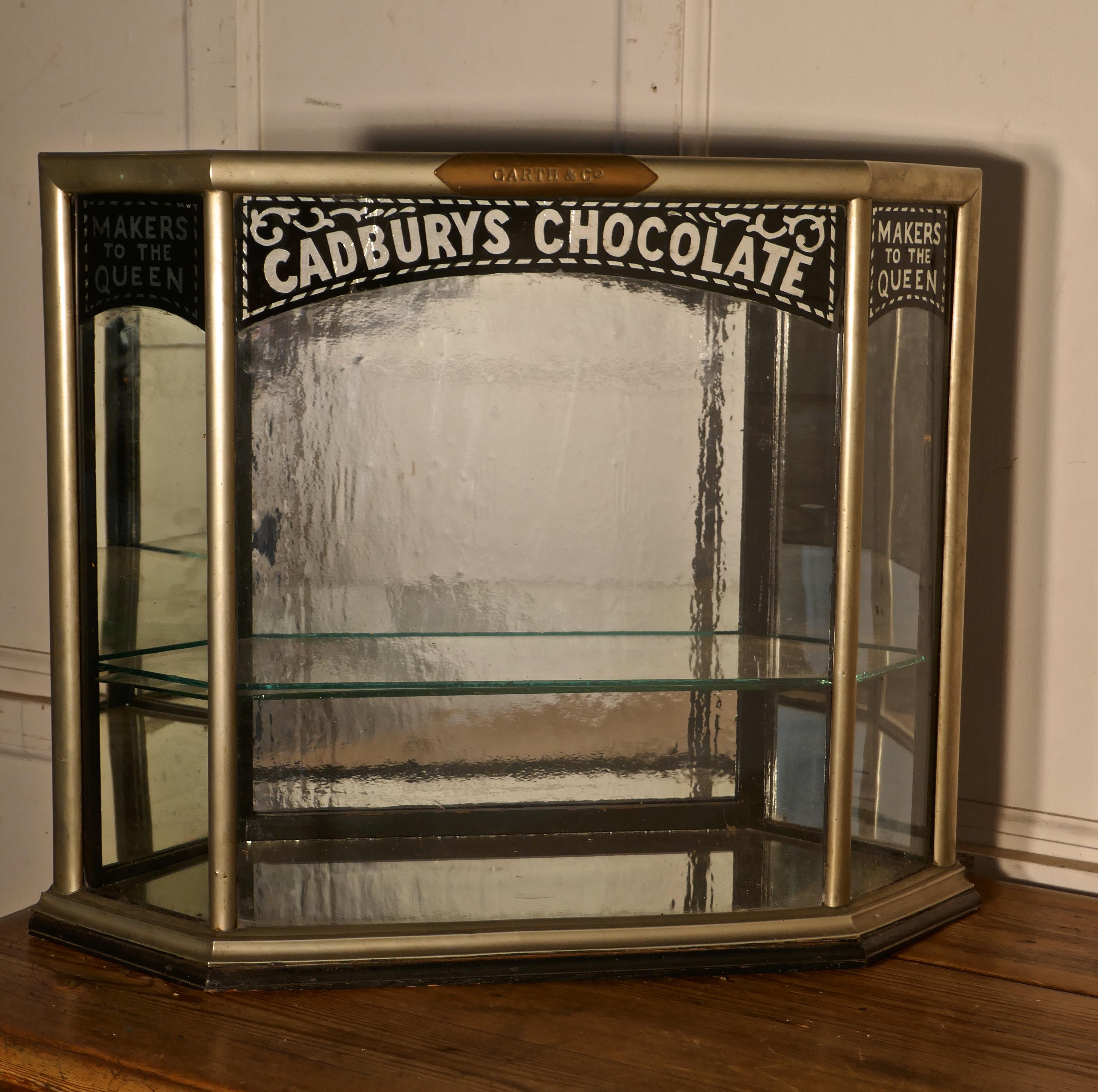 Cadbury’s Art Deco Display Cabinet, Art Deco Crome

This a small but Charming Cadbury’s Sweet Shop Display Cabinet it is a counter top piece, from above you can see it is in the shape of a Convex Hexagon, with a small door at each end,
The cabinet