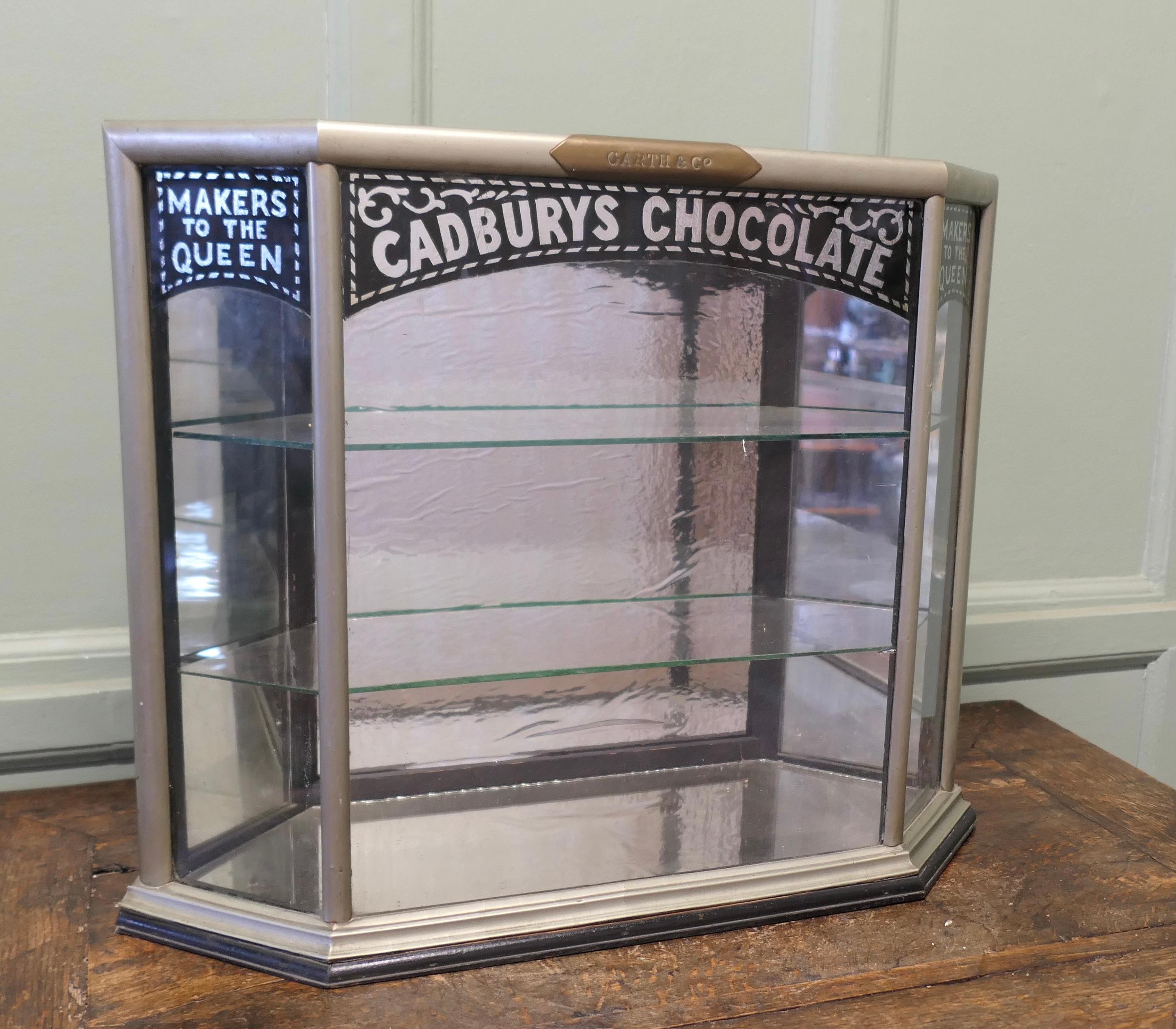 Cadbury’s Art Deco Sweet Shop Cabinet 

This is a small but Charming Cadbury’s Sweet Shop Display Cabinet it is a counter top piece, from above you can see it is in the shape of a Convex Hexagon, with a small door at each end and it has 2 glass
