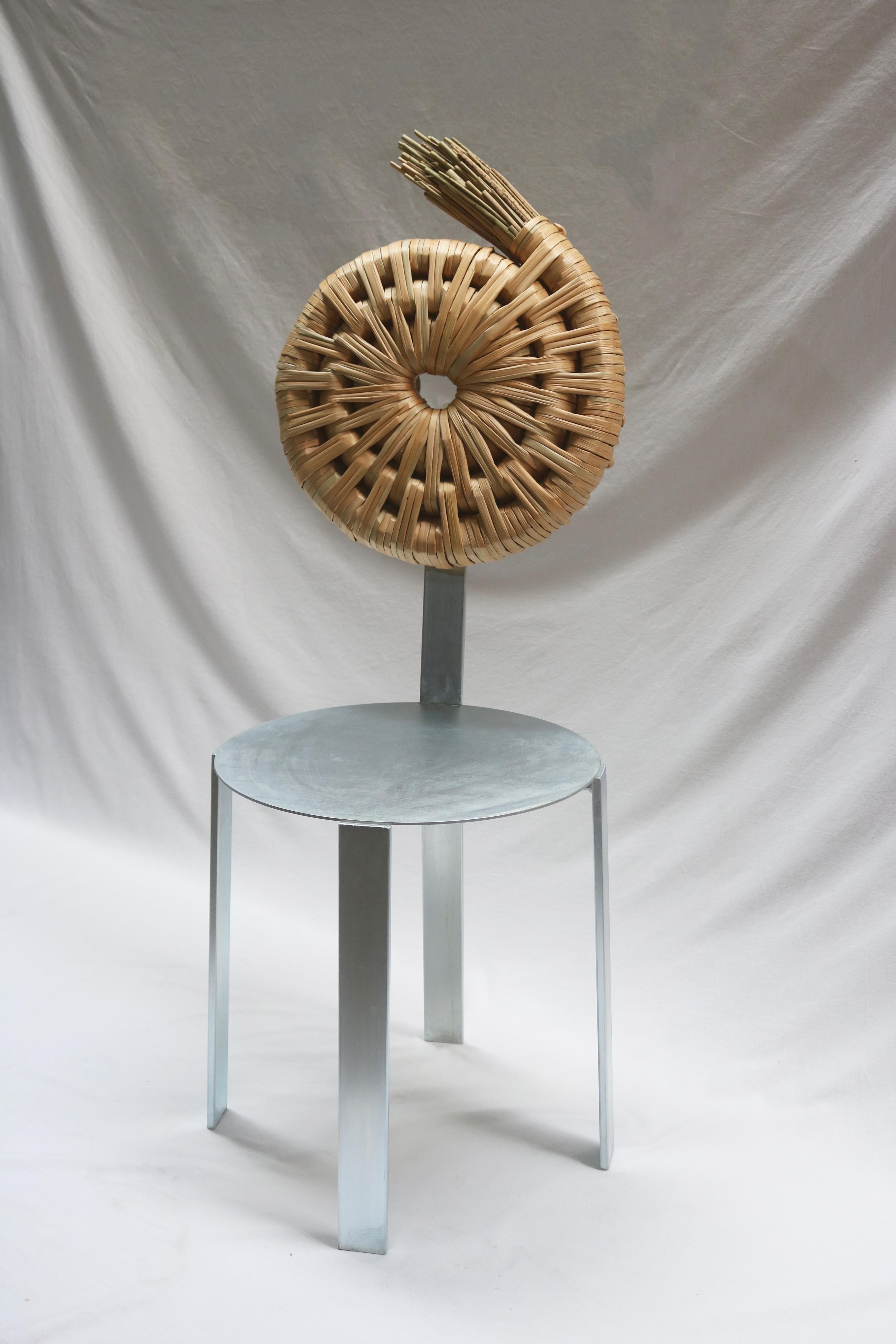 Cadeira Chair by Macheia
Handmade In Portugal.
Dimensions: D 45 x W 45 x H 88 cm.
Materials: Natural dried bulrush and galvanized iron.

The chair’s concept is rooted in the notion that every spiral starts around a hand. The hole, the
imprint of the