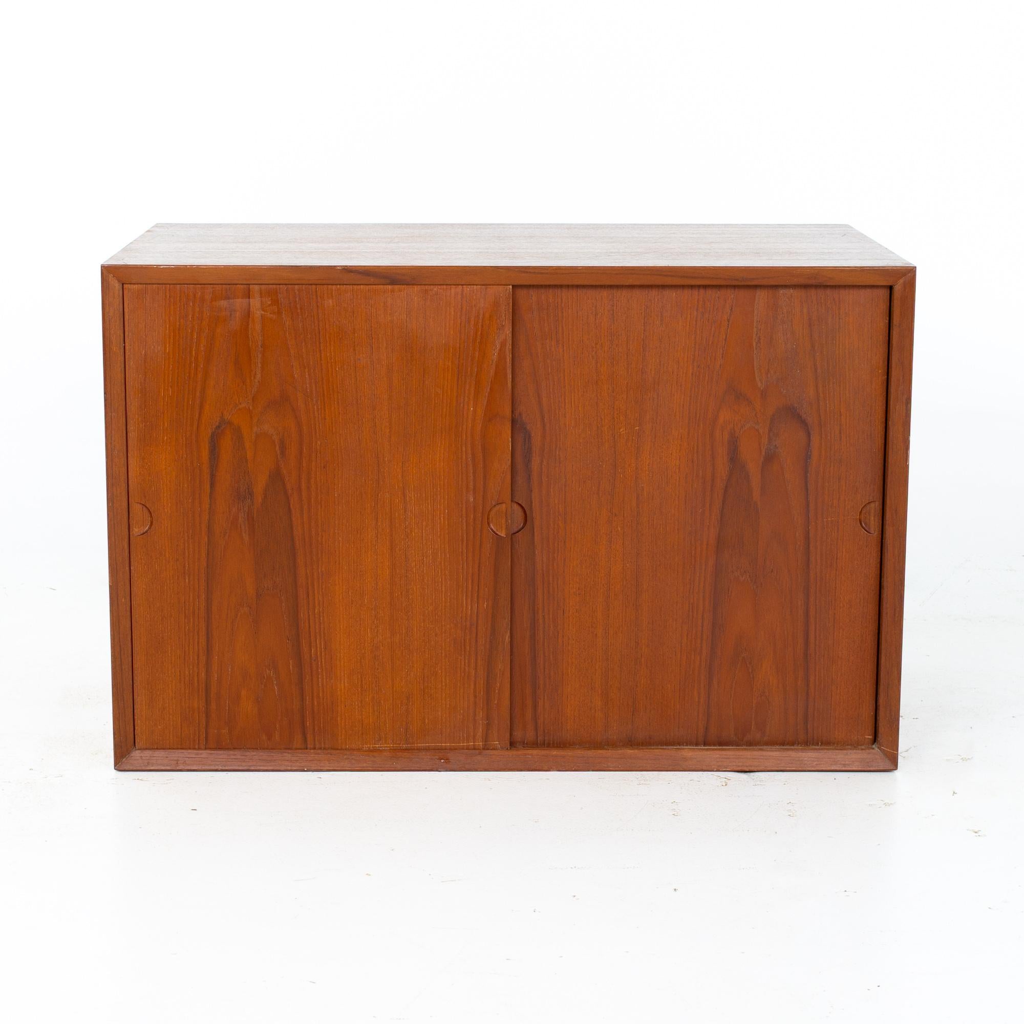 Cado Mid Century Teak Sliding Door Wall Unit Box

Wall unit box measures: 31.5 wide x 18 deep x 20.5 inches high

All pieces of furniture can be had in what we call restored vintage condition. That means the piece is restored upon purchase so