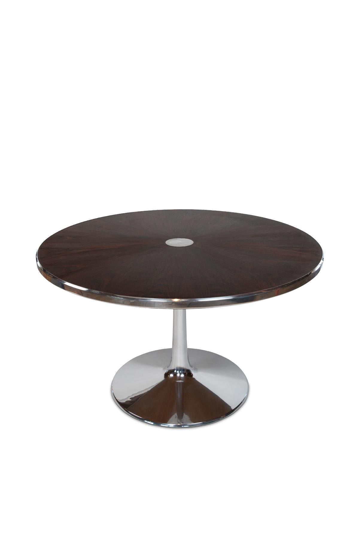 Rosewood and polished aluminum dining table by Cado circa late 1960s. This example has stunning book matched rosewood that has been newly finished and the tulip base and trim have been polished.


