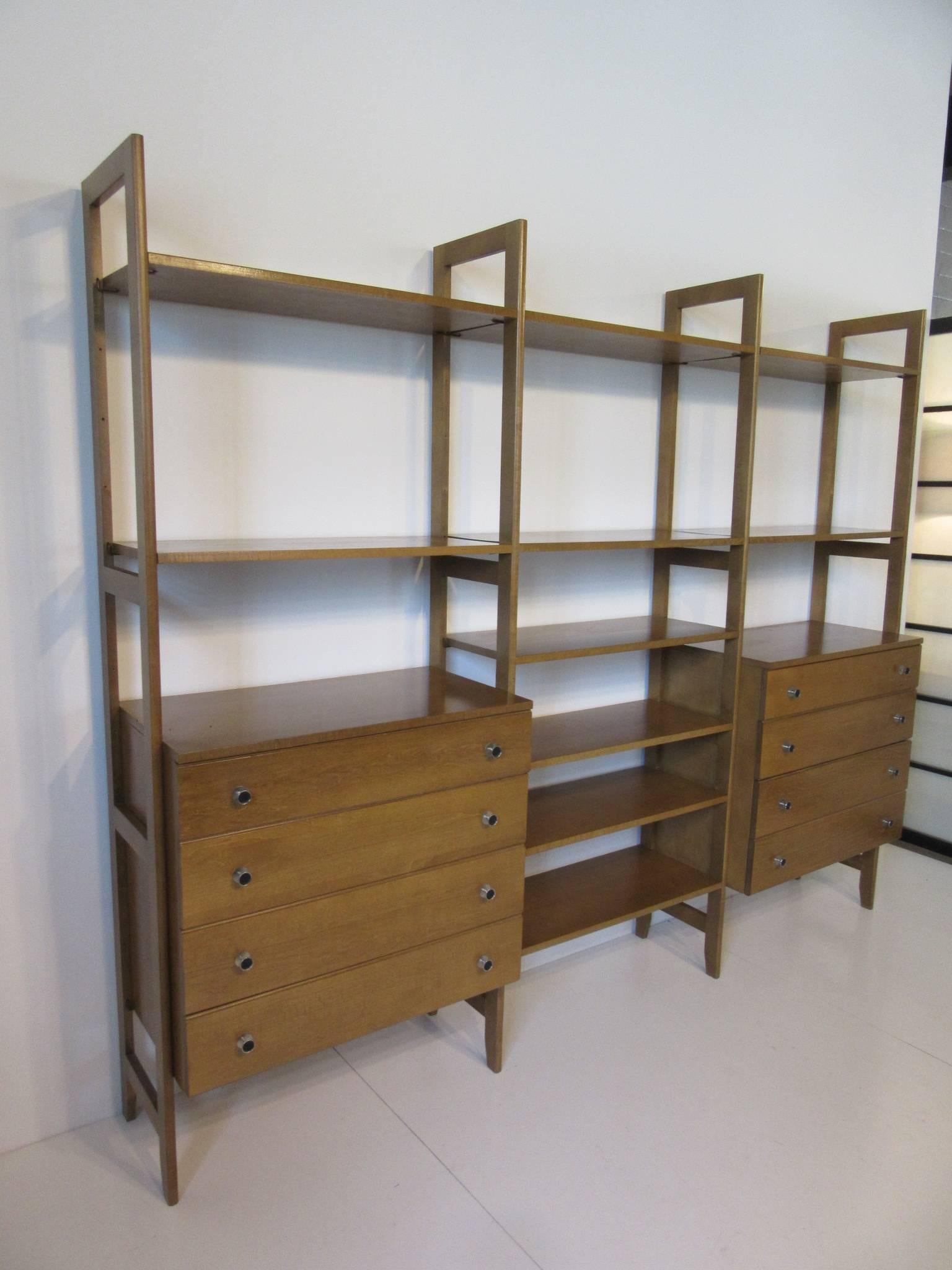 A freestanding with no wall attachment storage system in the style of the Cado units with three bays , two four drawer chests , chrome pulls and ten shelves, all adjustable to fit your needs . Easy set up and very sturdy this is a great piece for