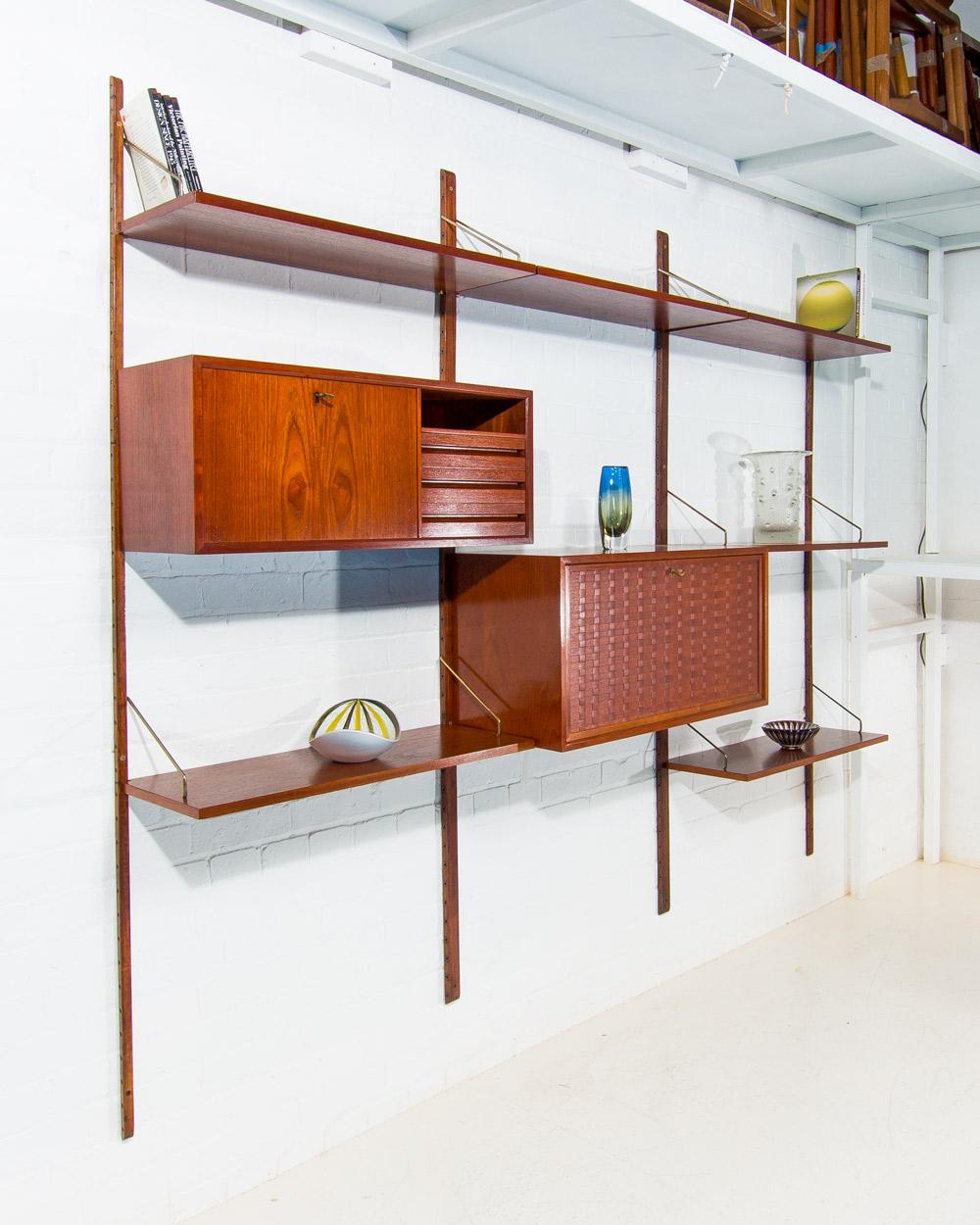 This stunning Cado wall unit, designed by Poul Cadovius in the late 1940s, is a classic example of Danish modern design. This Royal System consists of two functional units: one features a drop-down writing bar, pull-out drawers, and ample workspace,