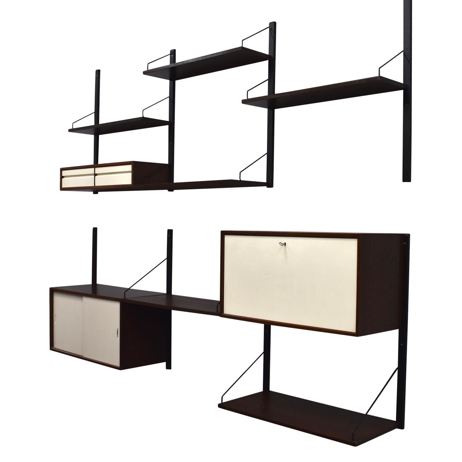 Large Poul Cadovius wall unit in wenge wood and white lacquered wood. It can be split up in multiple smaller units or one large unit.
It features:
8 wall mounts
3 cabinets
4 book shelves
2 desk shelves
Metal hinges and other mounting material