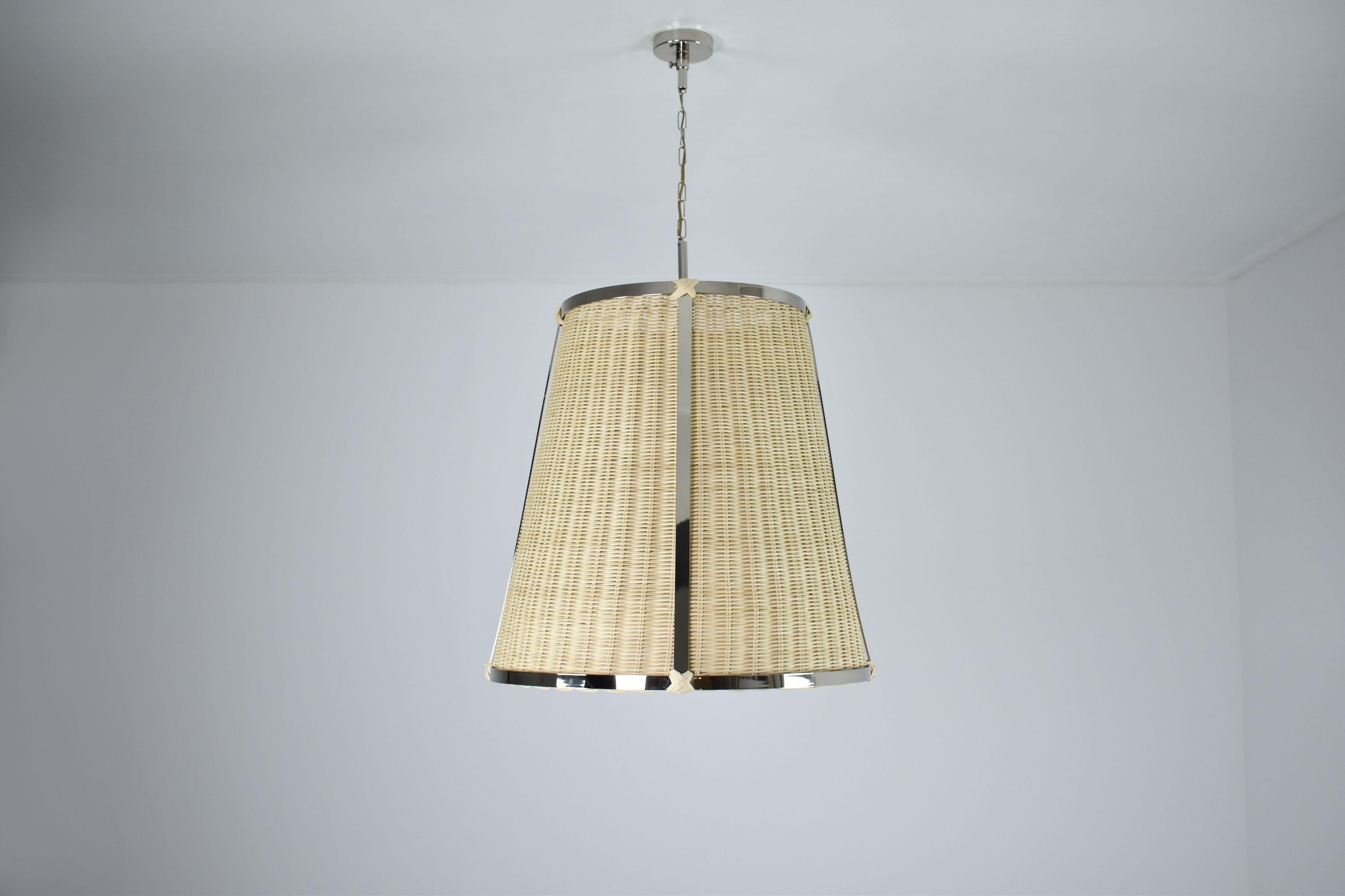 This pendant light fixture is a contemporary, made-to-Measure piece that is perfect for living areas or as kitchen island lights. The fixture is composed of a brass nickel-plated structure that has been expertly handcrafted, and a meticulously