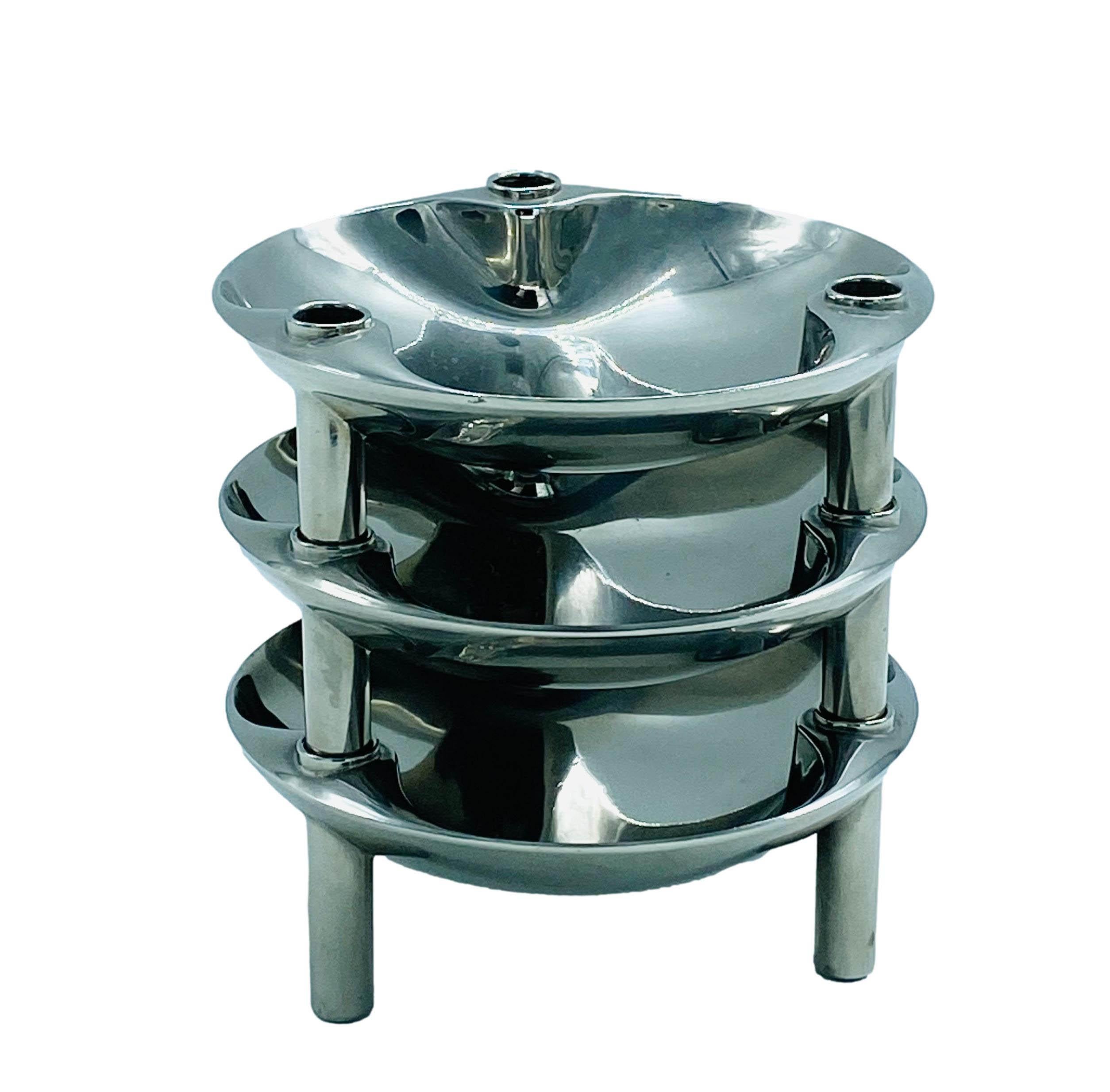 A rare set of classic candle bowls in chrome-plated metal by designer Fritz Nagel, for Caesar Stoffi with three dishes. The set contains 9 candle segments and three plates. It can be configured in various ways, either vertically or horizontally by