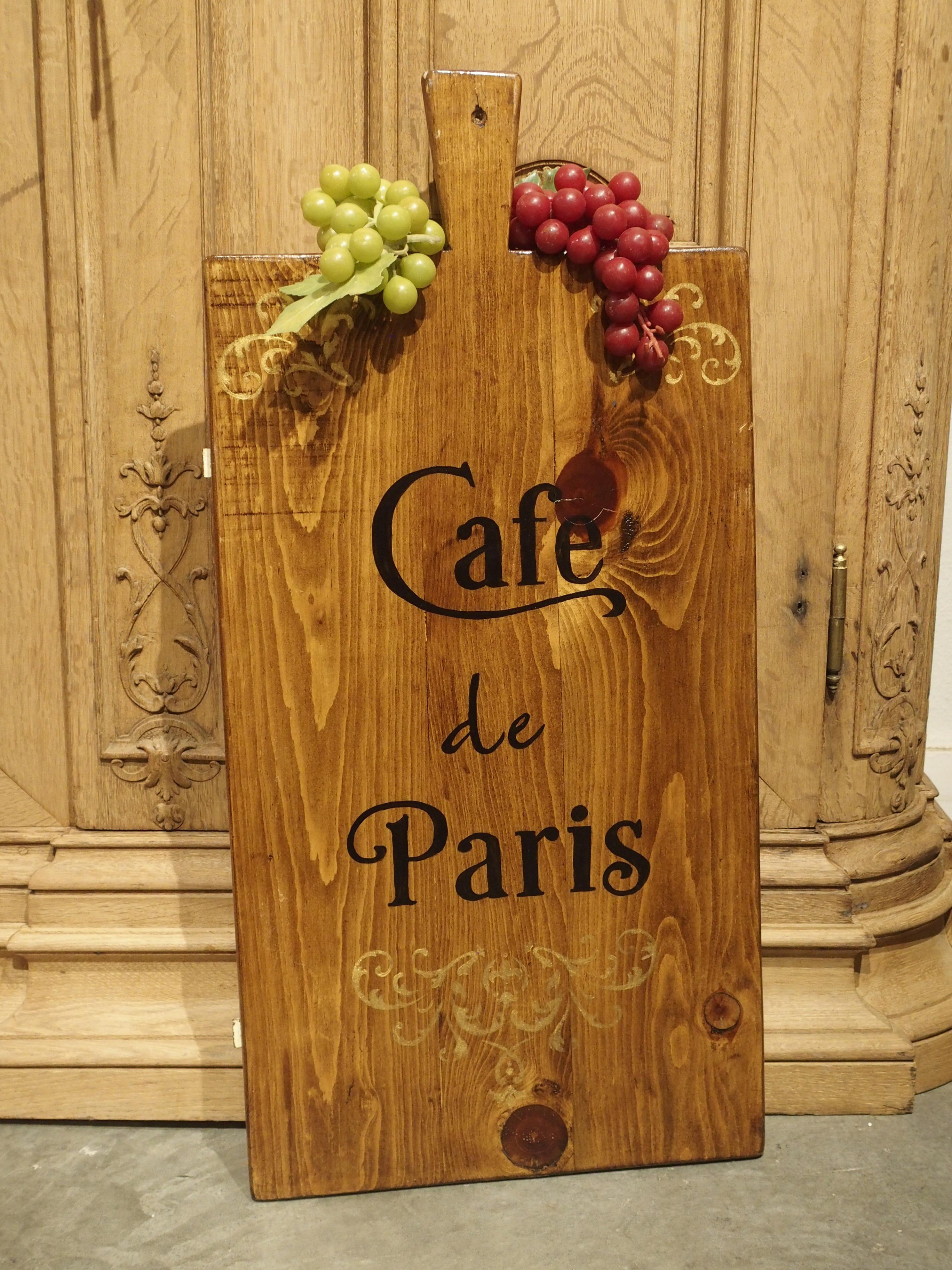 Hang this painted wooden board in the kitchen as decoration, and use it as a charcuterie and cheese board for when guests arrive. “Cafe de Paris” is hand painted in black letters, while the two upper corners and lower section has painted scrollwork