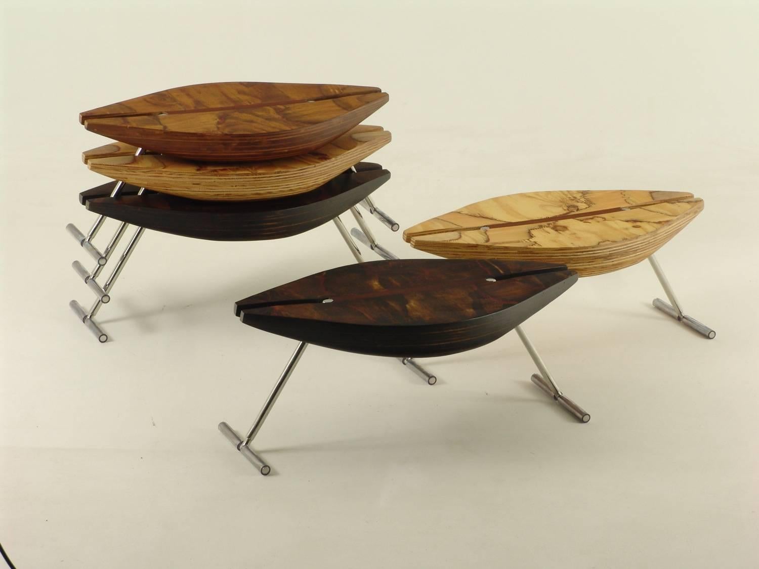 Stackable low stool, with multi laminated seating molded by organical forms and inoxidable foots.