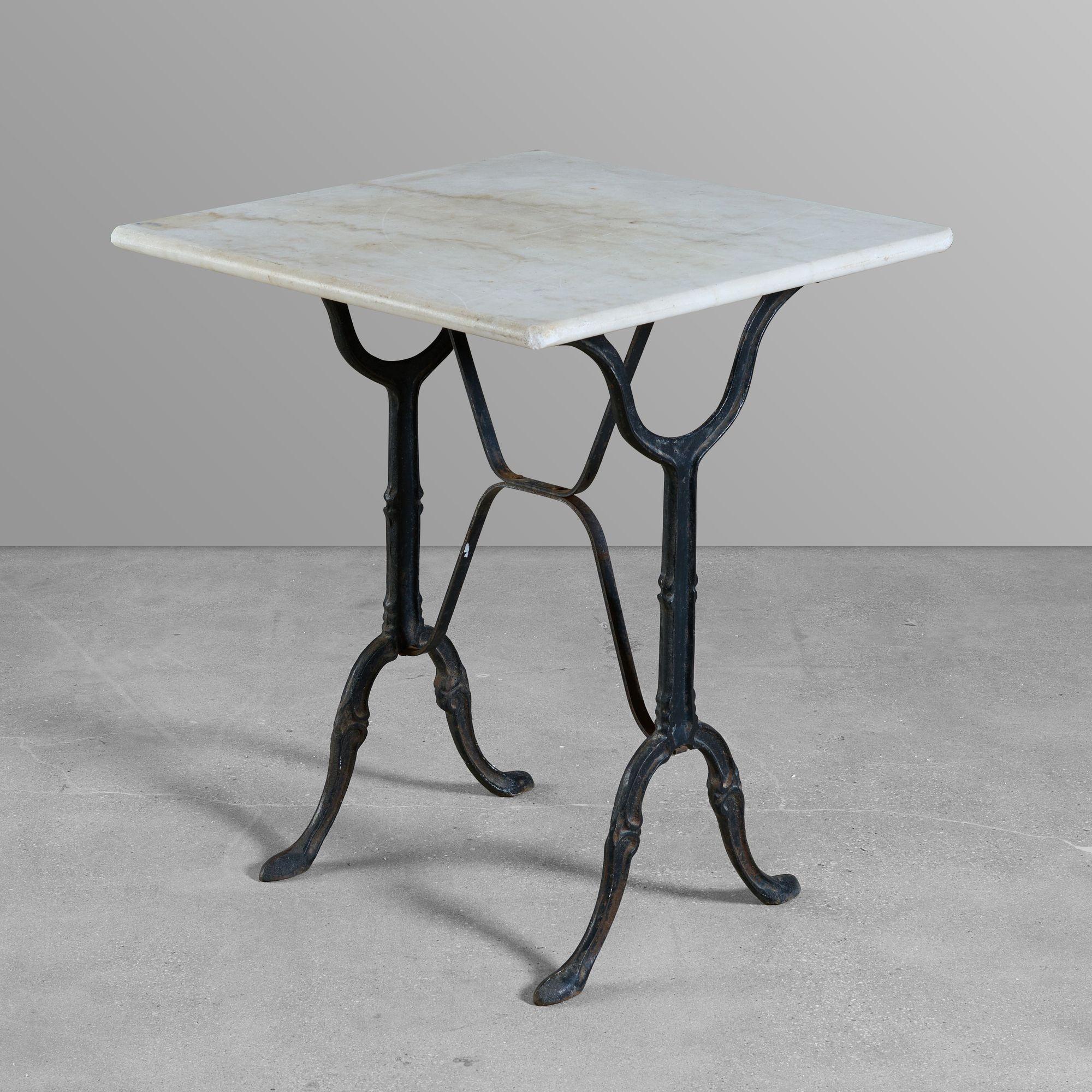 Cast iron cafe table with a marble top.