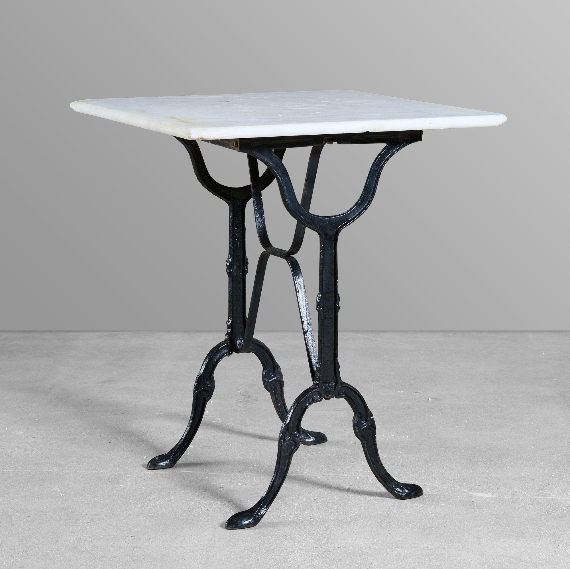 Cast iron cafe table with a marble top.