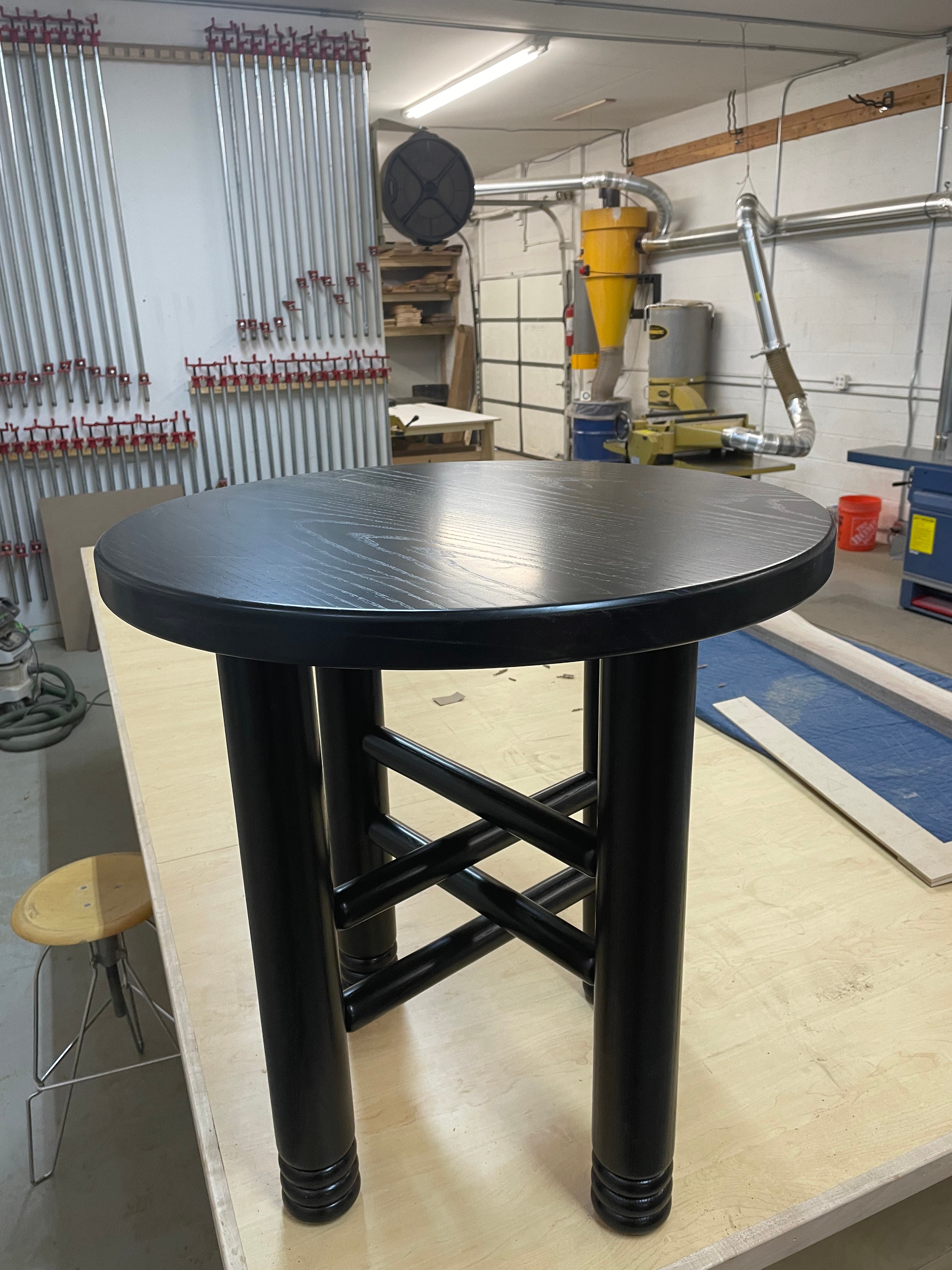 This cafe table in turned ash with a beaded leg detail is inspired by a cafe table I saw in France. The cross of the stretchers in the base is an unusual design element that creates visual complexity from simple traditional joinery. The bead details