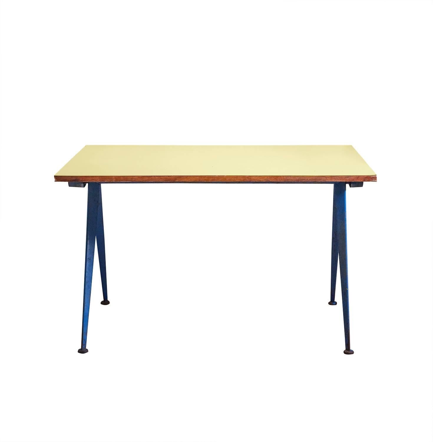 Compas table, model Cafétéria n. 512 table, designed by Jean Prouvé 
Bent sheet steel and laminated wood. 
In yellow and blue.
    