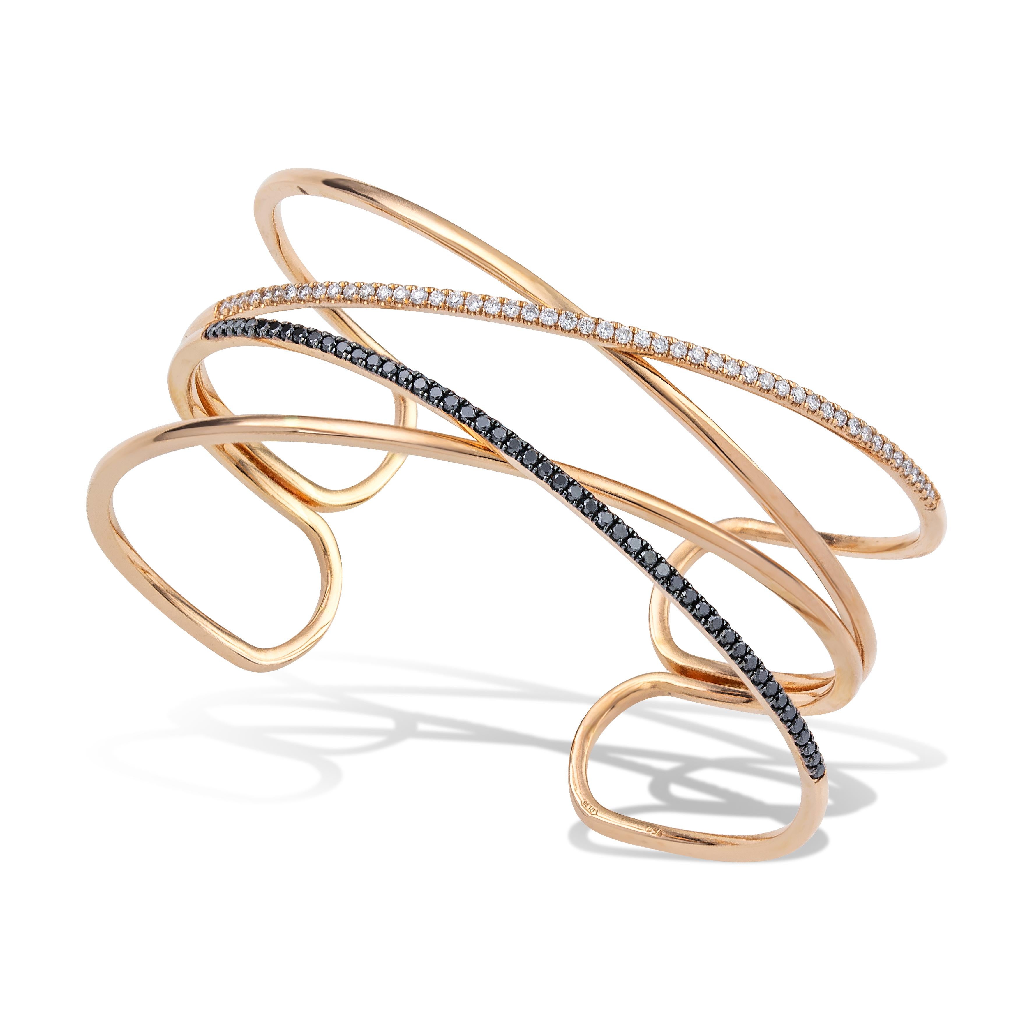 Unique Cage Cuff Bracelet with white and black brilliant cut diamonds handcrafted in 18Kt Rose gold. 
Elegant stripes of 18Kt gold create the delicate shilouete of this bracelet around your wrist. The black diamonds contrast sharply with the white