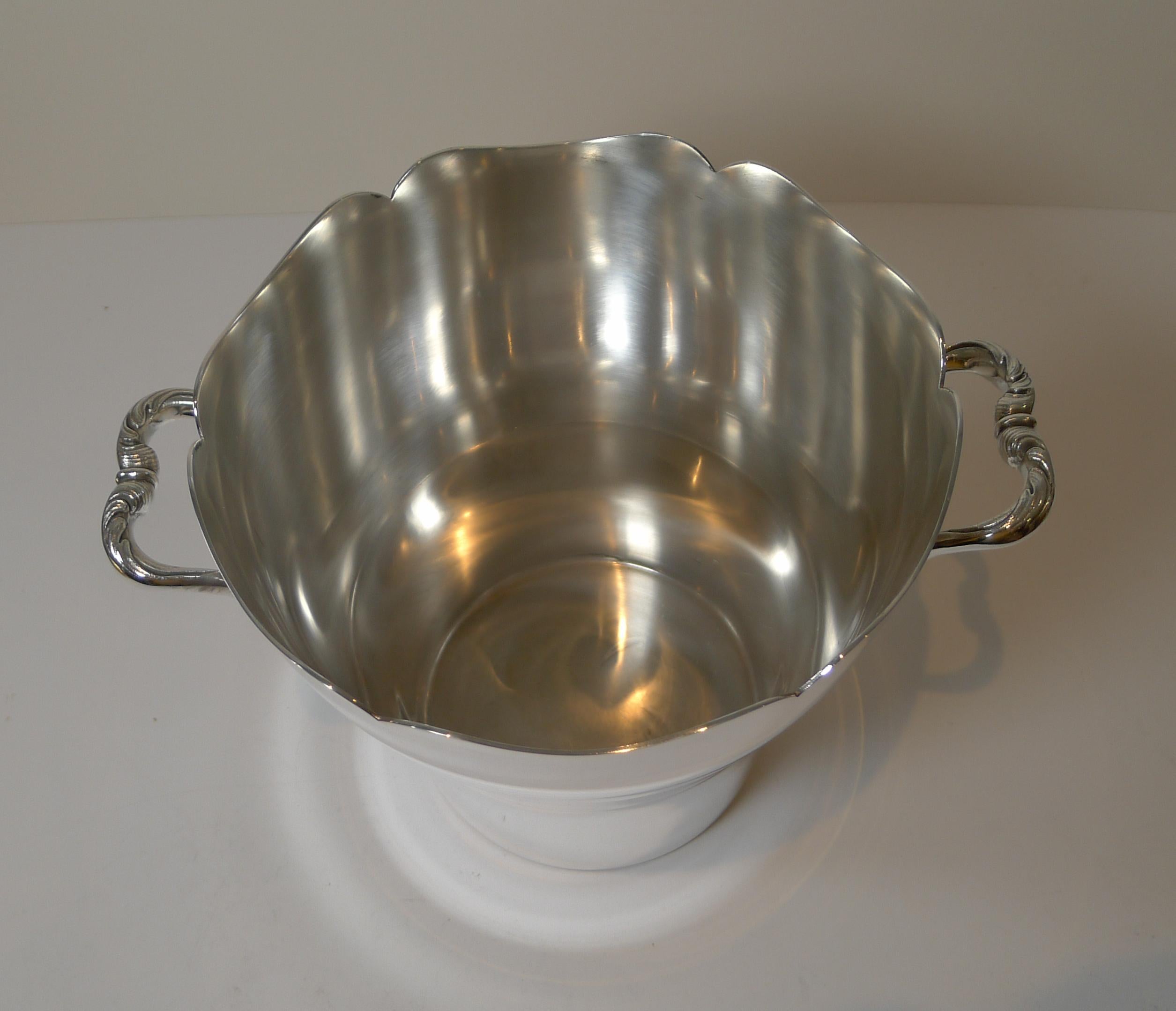 A very fine early twentieth century Champagne bucket; a beautiful shaped body with a scallopped rim and very stylish handles.

The underside is signed by the top-notch Parisian silversmith, Cailar & Bayard.

Cailar & Bayard, 37 rue
