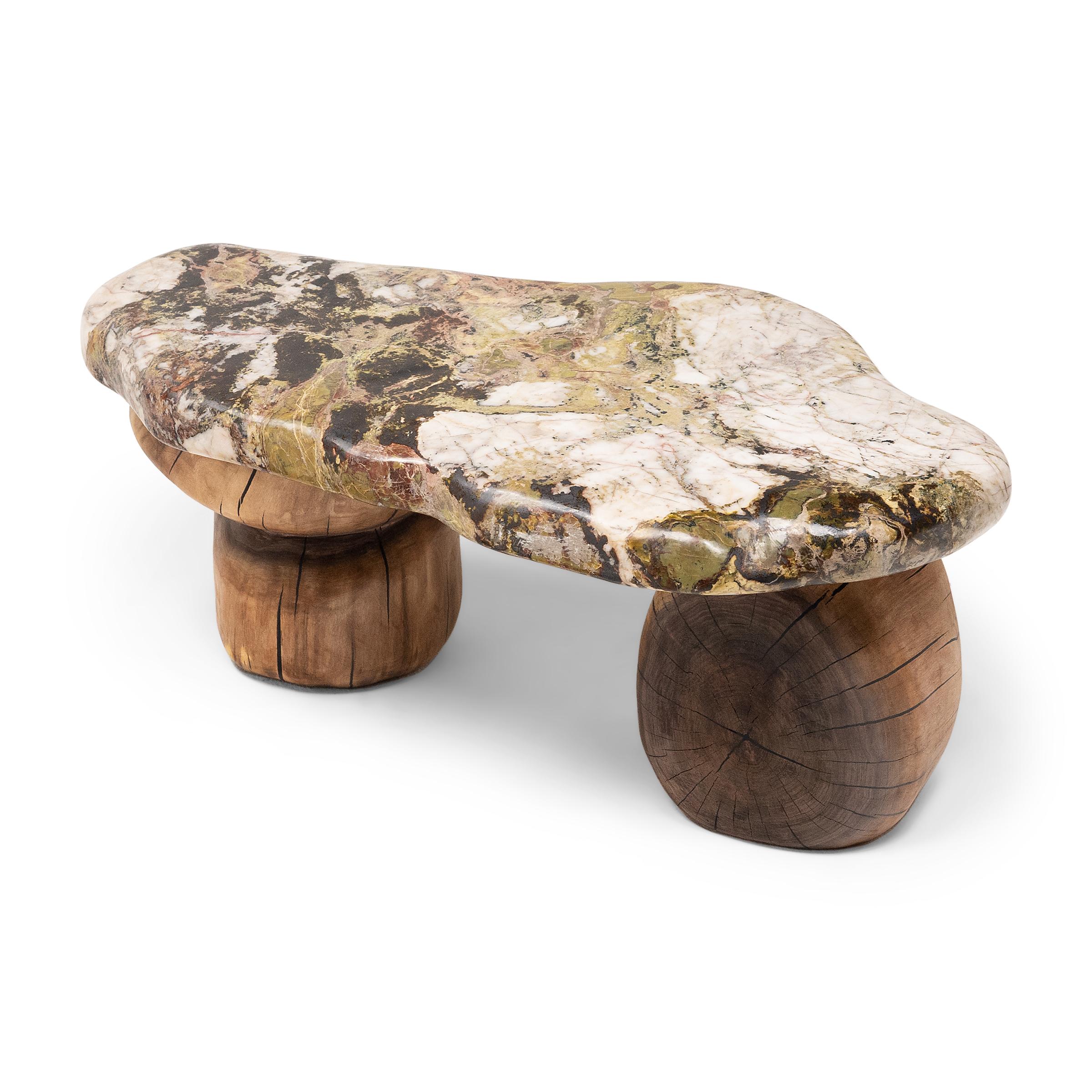 This small stone top table exemplifies Organic Modern style with an emphasis on natural materials. The organic shape and irregular patterning of the stone slab top evokes the complexities of nature, reminiscent of a mossy cliffside or a calm river