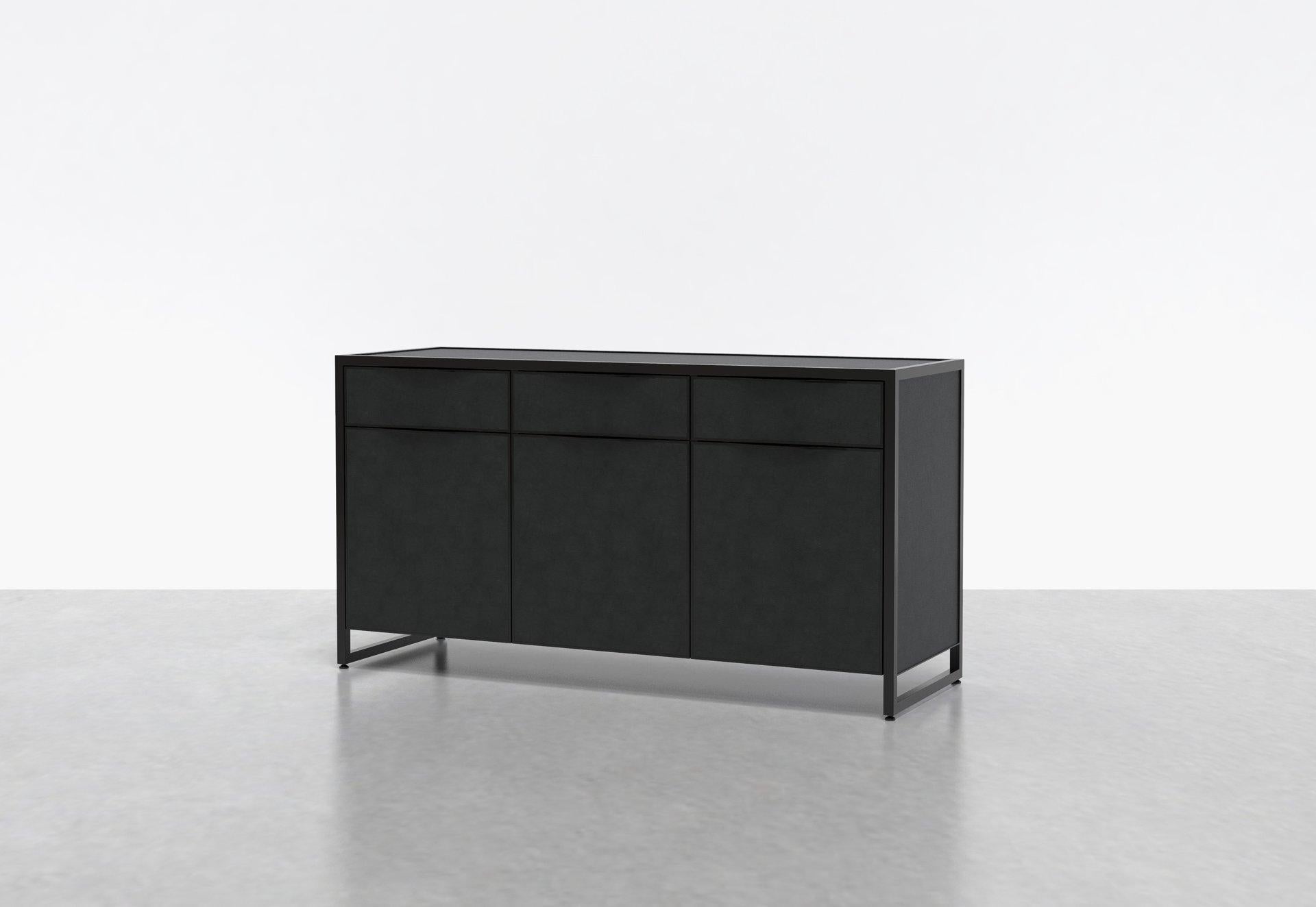 Two of our favorite materials, leather and steel, come together in the Cairns Credenza. This luxe console or media unit combines leather-clad surfaces with a steel frame. Four drawers sit above four doors that conceal adjustable shelves, providing