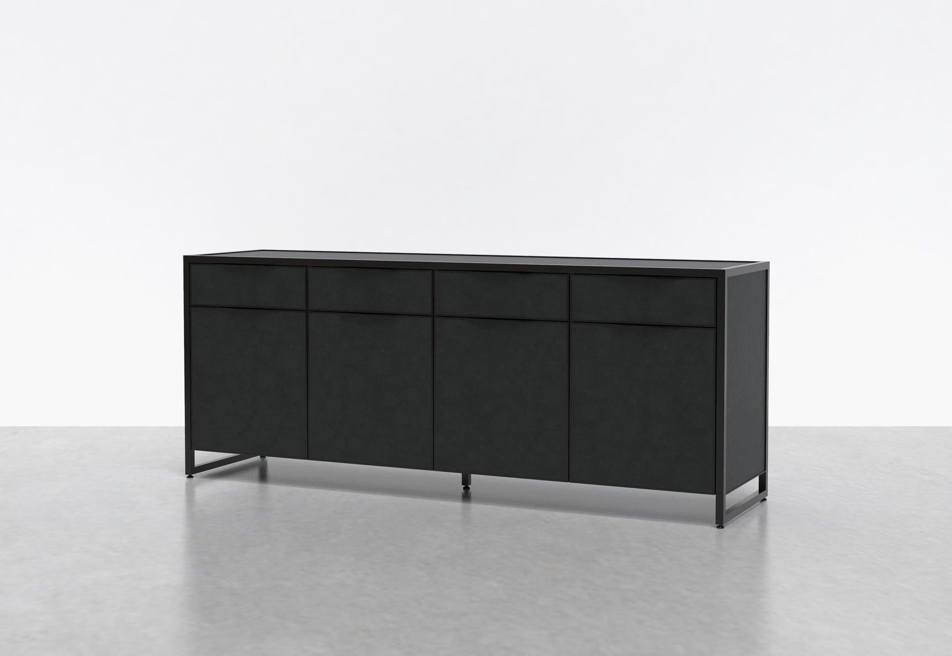 Two of our favorite materials, leather and steel, come together in the Cairns Credenza. This luxe console or media unit combines leather-clad surfaces with a steel frame. Four drawers sit above four doors that conceal adjustable shelves, providing