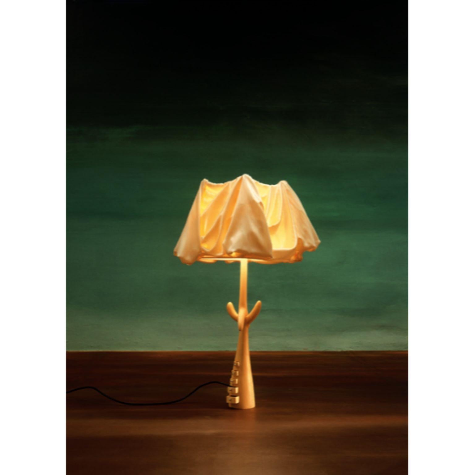 Muletas lamp, Salvador Dalí
Dimensions: 30 x 30 x 87 H cm
Materials: Carved structure in pale varnished lime-wood.
Lamp shade in beige linen.

The Bracelli lamp has a wooden board structure covered in fine gilding also available in a darker version.
