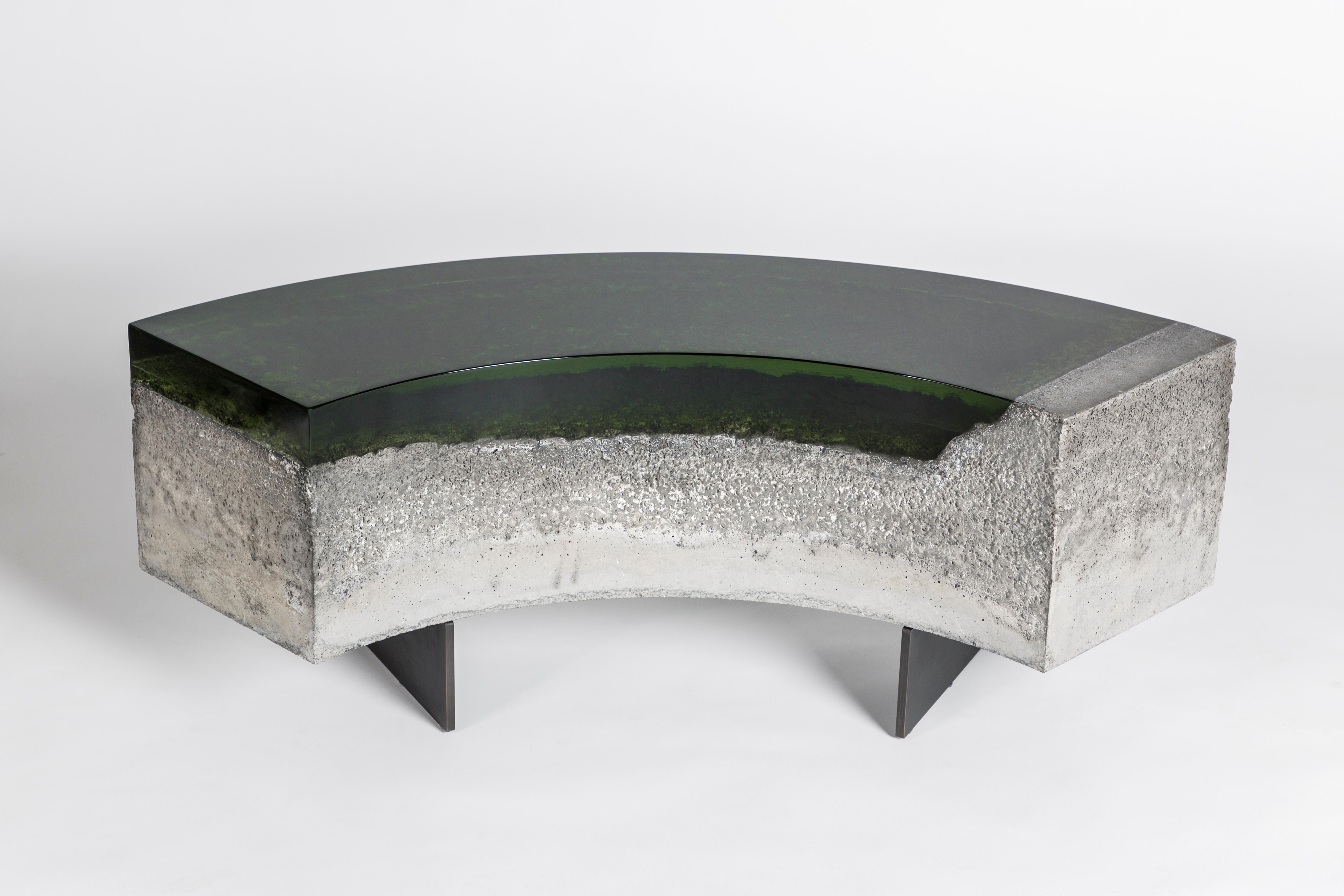 Featuring a juxtaposition of cast resin and concrete, these benches have been inspired by Lake Como and its countless shades. The resin, in the tones of blue and green, looks like water, revealing the concrete seabed. 
The colors of Draga&Aurel