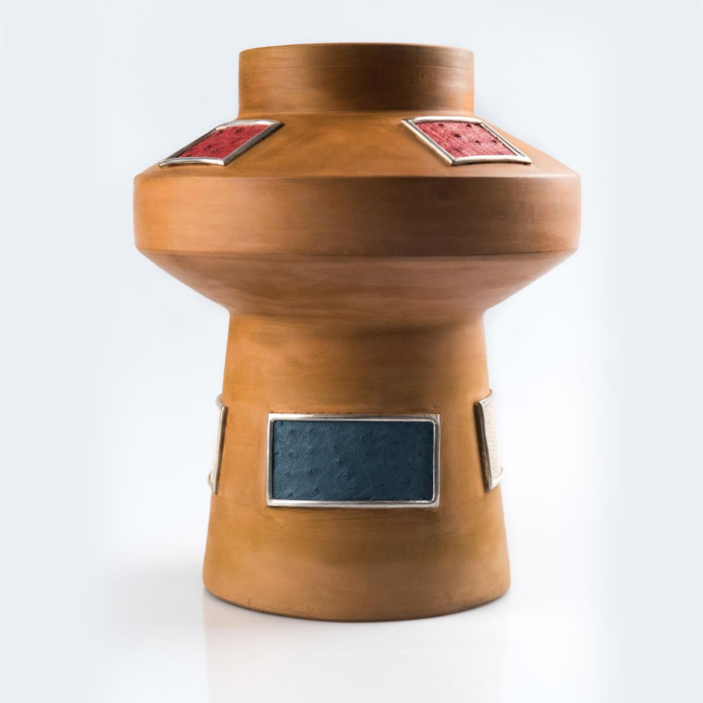 An extraordinary artwork that displays deft craftsmanship and unprecedented style, this gorgeous vase features a singular and imposing silhouette that will make a statement in any interior decor. It is handmade of earthenware finished with beeswax
