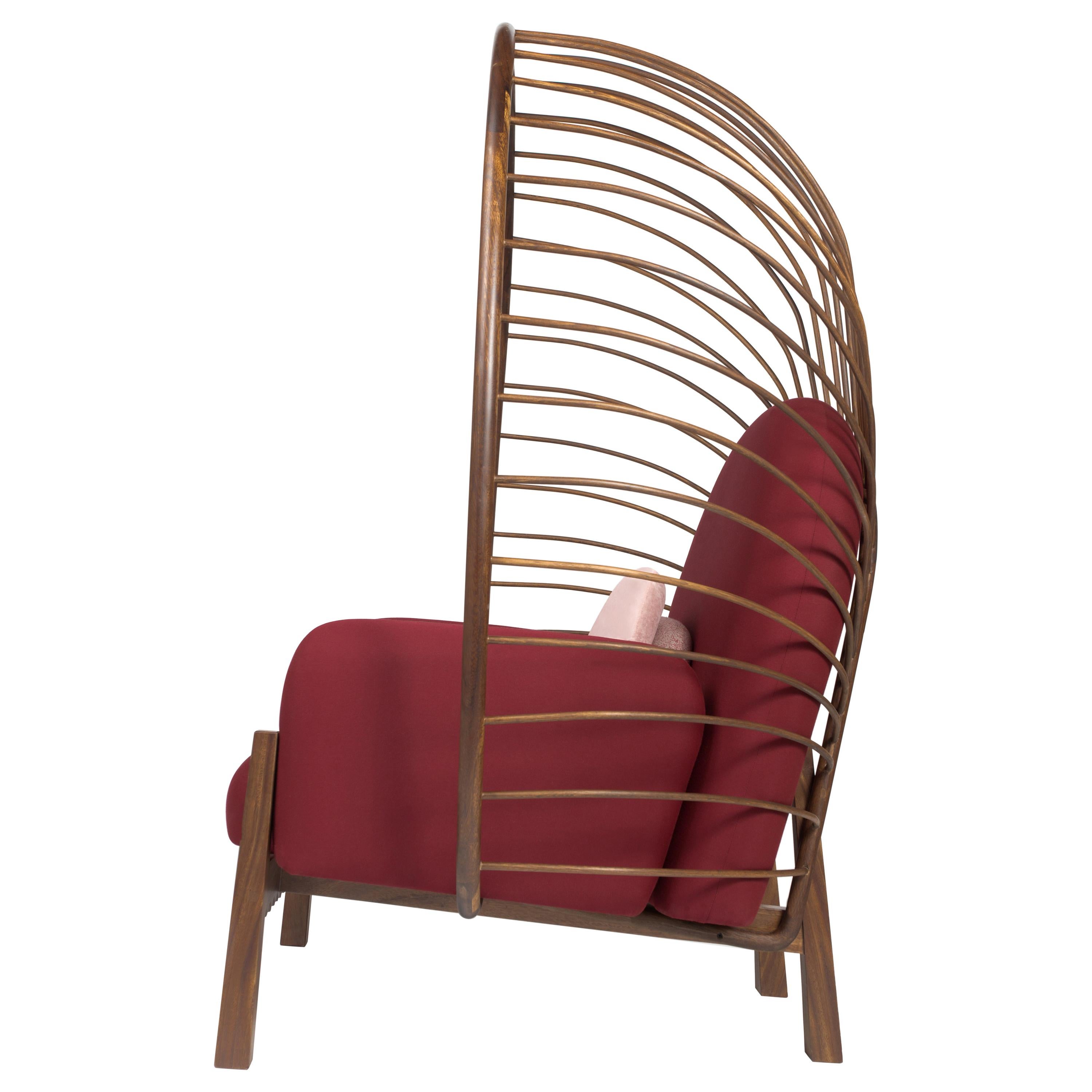 This elegant and striking armchair was designed to highlight outdoor spaces with its magnitude and organic form. Perfect for a relaxing outdoor area.  One can almost feel protected by its crown backing. Made of solid tropical Huanacaxtle wood. The