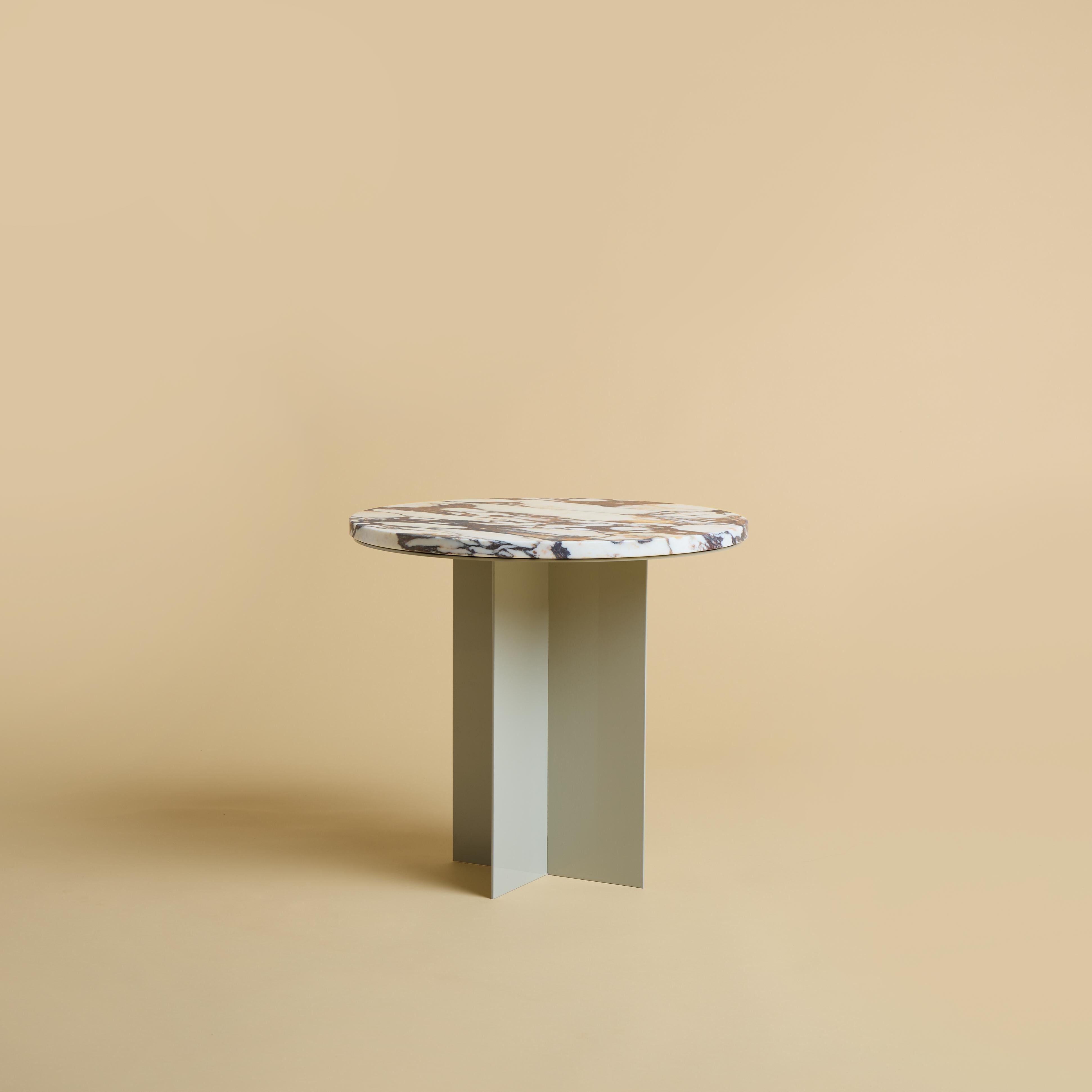 The Baker coffee table is produced with a powder-coated metal base and a top in Calacatta Viola marble from Tuscany region of Italy. The top is circular and has a diameter of 45cm, while the base is obtained by gluing metal plates perpendicular to