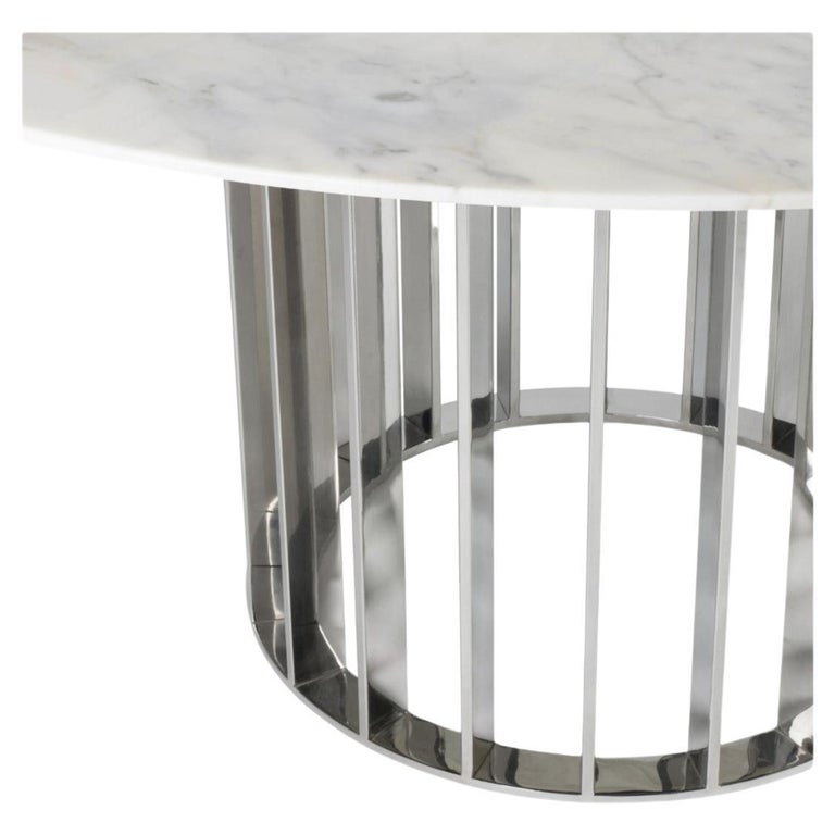 This unique dining table uses gorgeous Calacatta marble top and elegant and modern stainless steel base uses the repetition of metal stripes to bring rhythm to the base. Its design is simple but full of grace and WOW factor. 
Calacatta Marble is