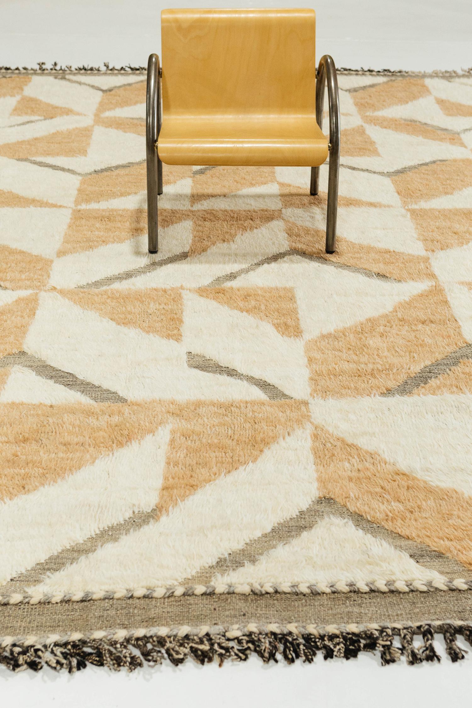 Handwoven of wool, Calcere uses geometric repeating patterns across the border. Peach toned orange and the perfect shade of white make up a short shag surface with a natural earth toned flat weave underlying the embossed detailing.