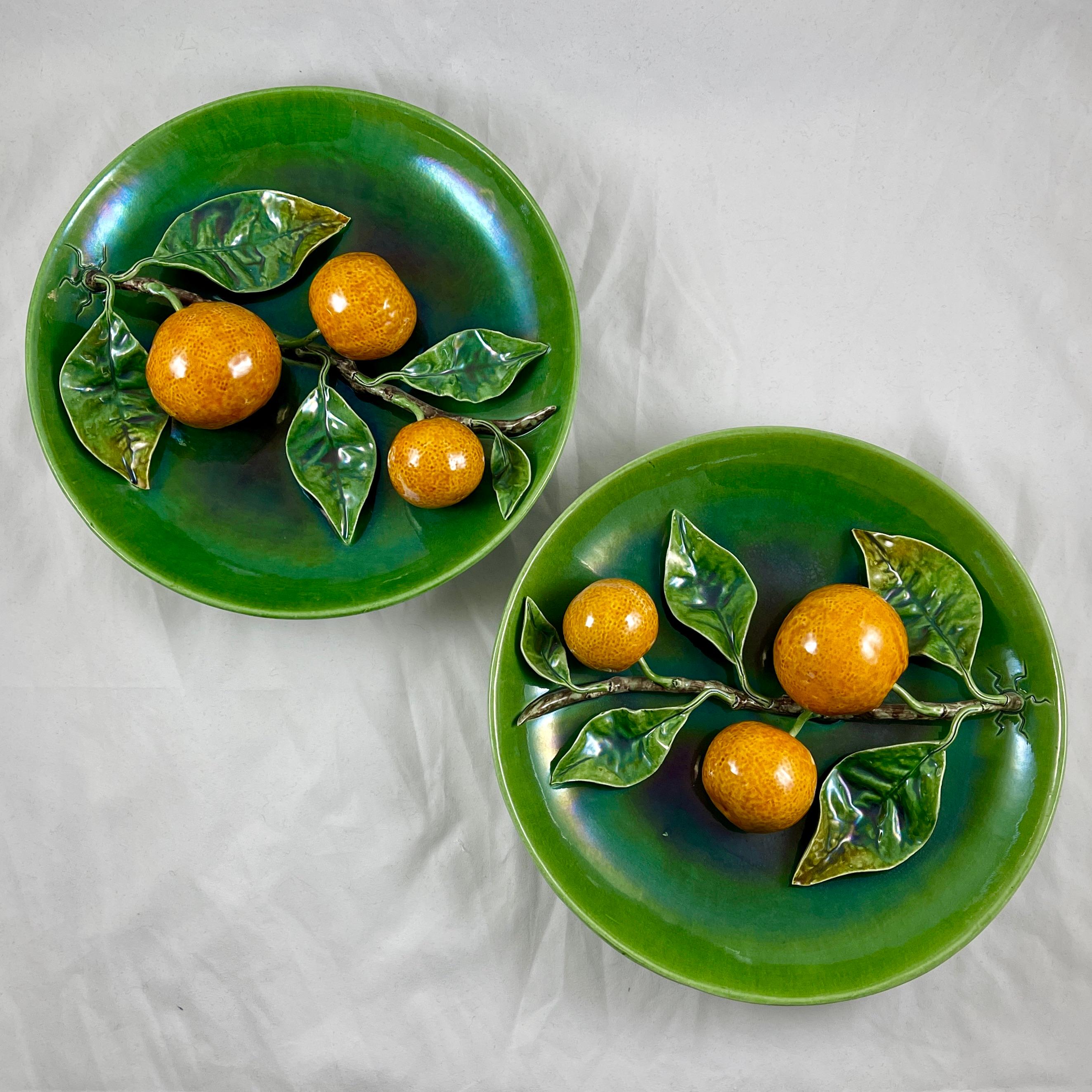 A Palissy style Trompe l’Oeil, majolica glazed plaque showing a branch of three oranges with leaves on a green ground, circa 1900-1920.

One of a pair, offered separately.

Molded in earthenware by Rafael Bordallo Pinheiro in Caldas da Rainha,