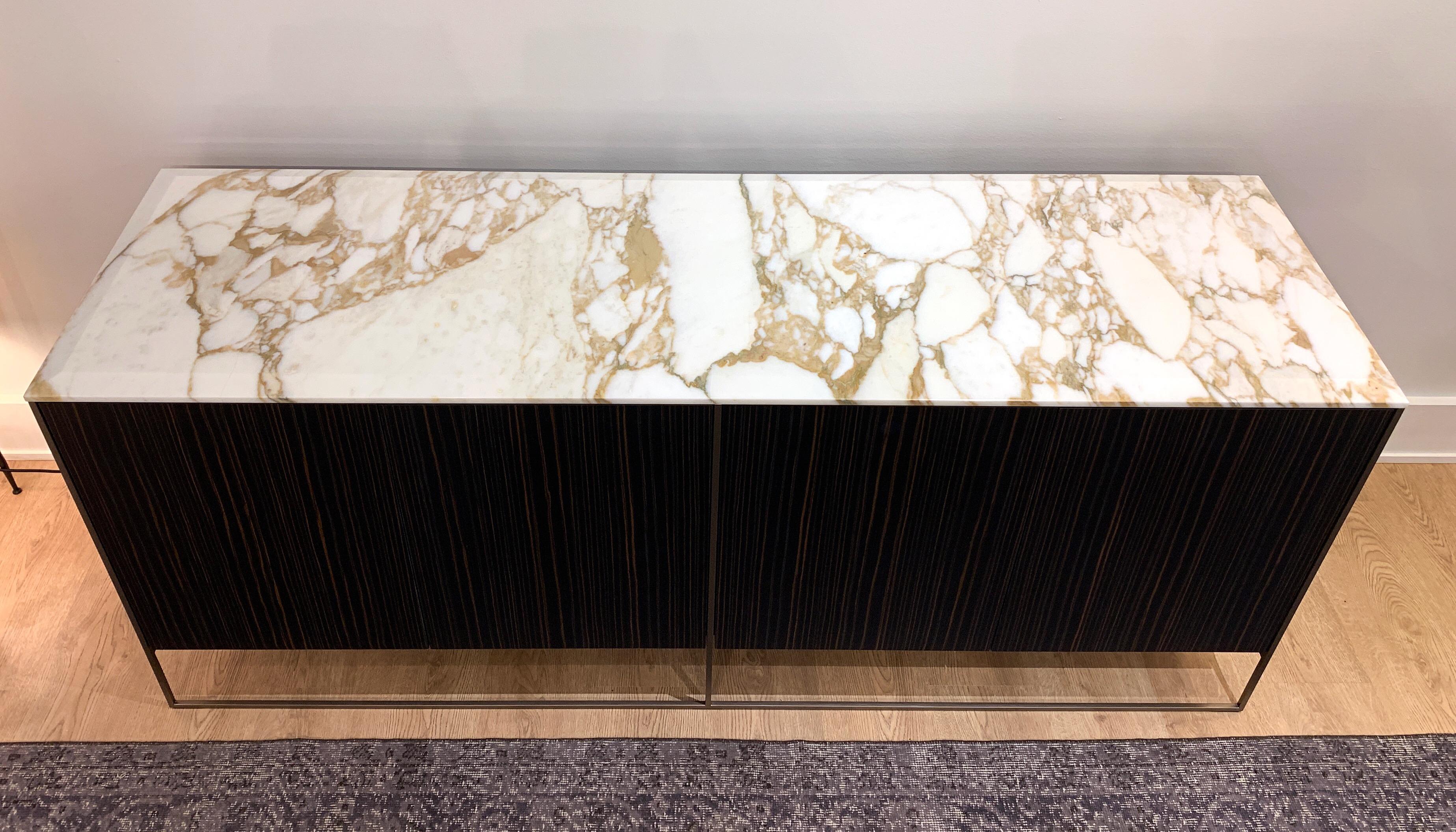 Dining sideboard with Calacatta Gold marble top, Sucupira veneer exterior, with drawers and mirrored interior. Designed by Rodolfo Dordoni for Minotti in 2017.
