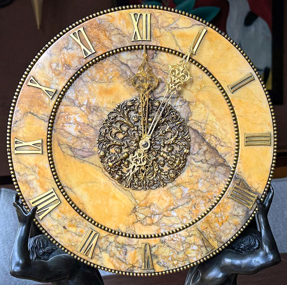 An extraordinary work of art by America's leading maker of luxe objects for homes and businesses in the early 20th century, this large and heavy Siena marble clock by J. E. Caldwell is supported by a pair of parcel gilt bronze caryatids with