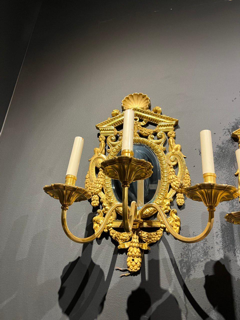Pair of Caldwell Neoclassic Sconces with Mirrored Backplate In Good Condition In New York, NY