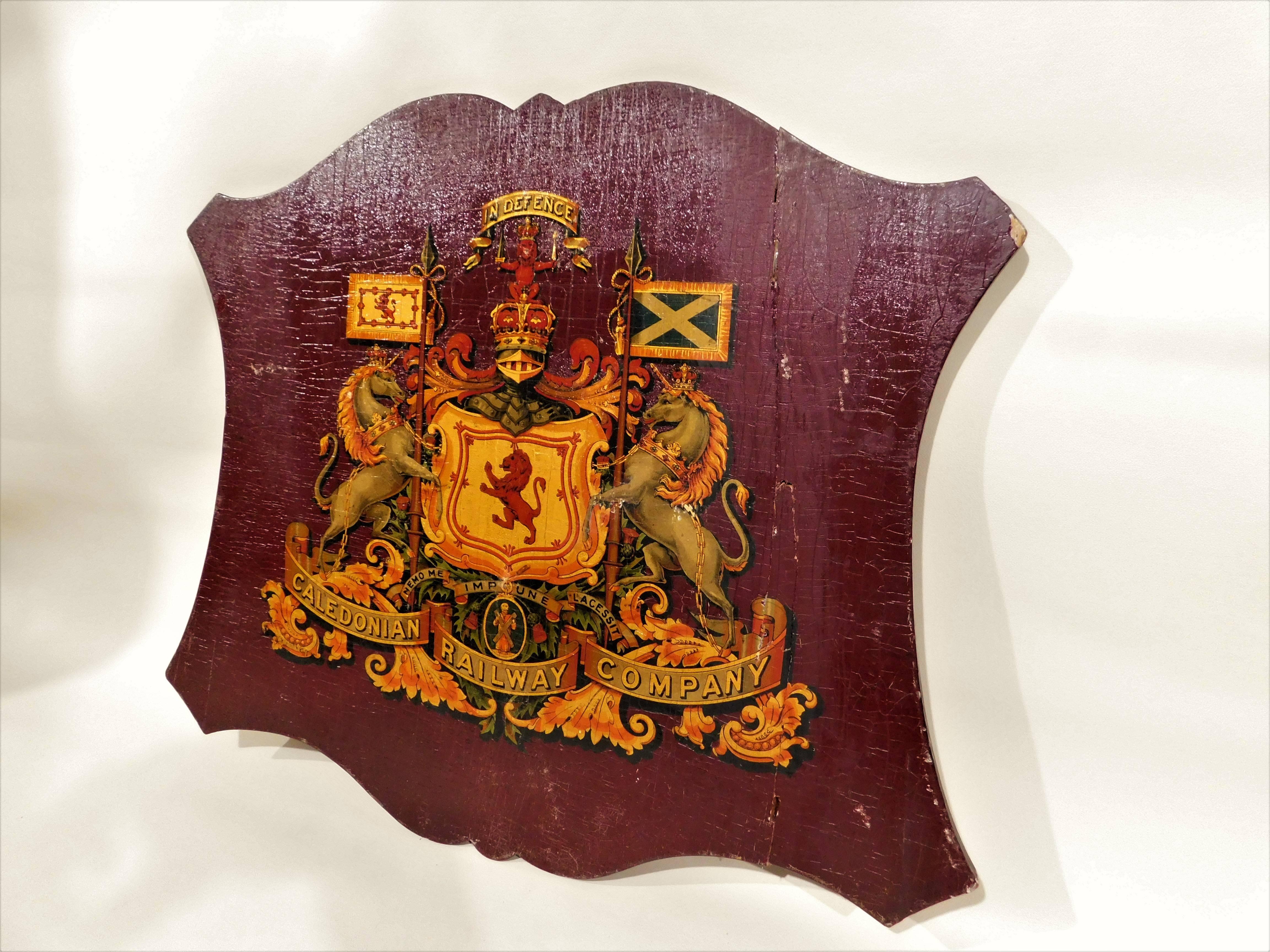 Caledonian Railway Company Coat of Arms mounted on a shield shaped wooden backing board. Scottish railroad train sign measures 20